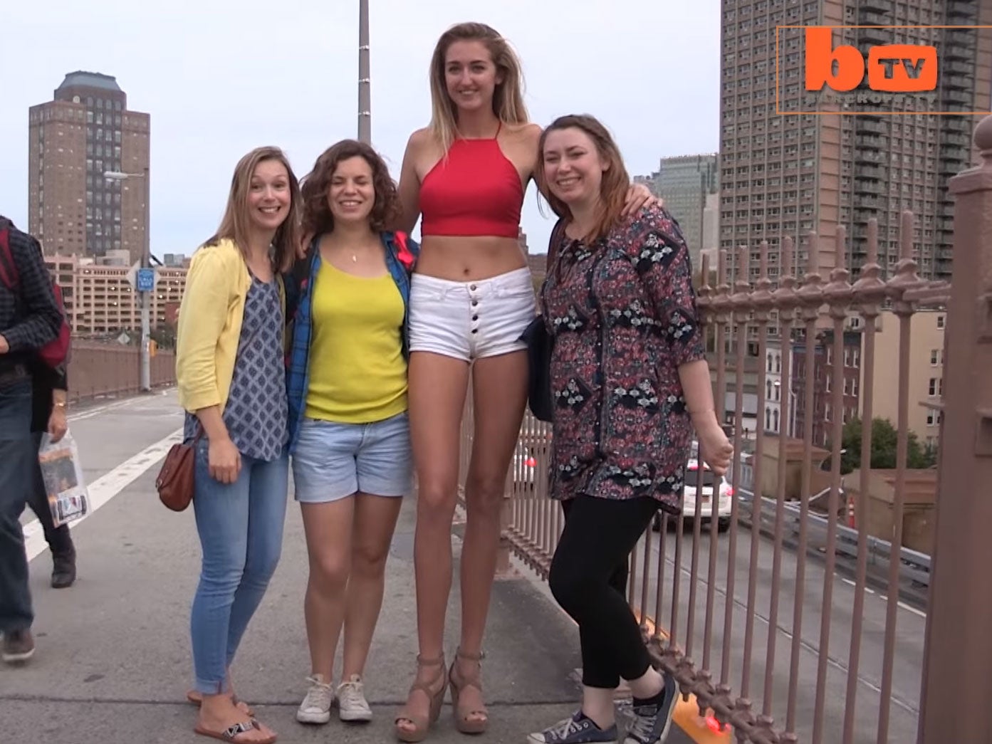 Holly Burt poses with impressed bystanders on Brooklyn Bridge