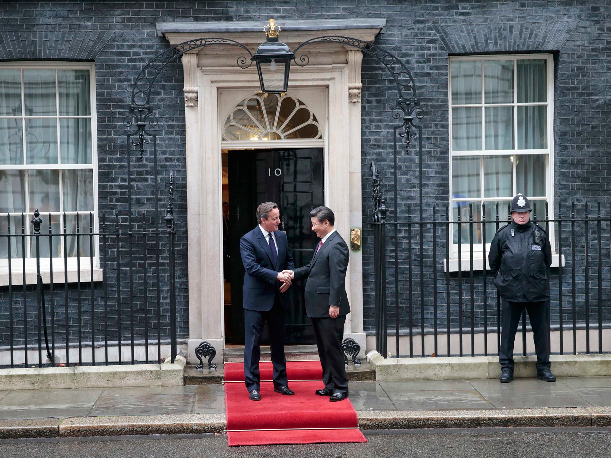 China's President Xi Jinping is welcomed by Britain's Prime Minister David Cameron to 10 Downing Street, in central London