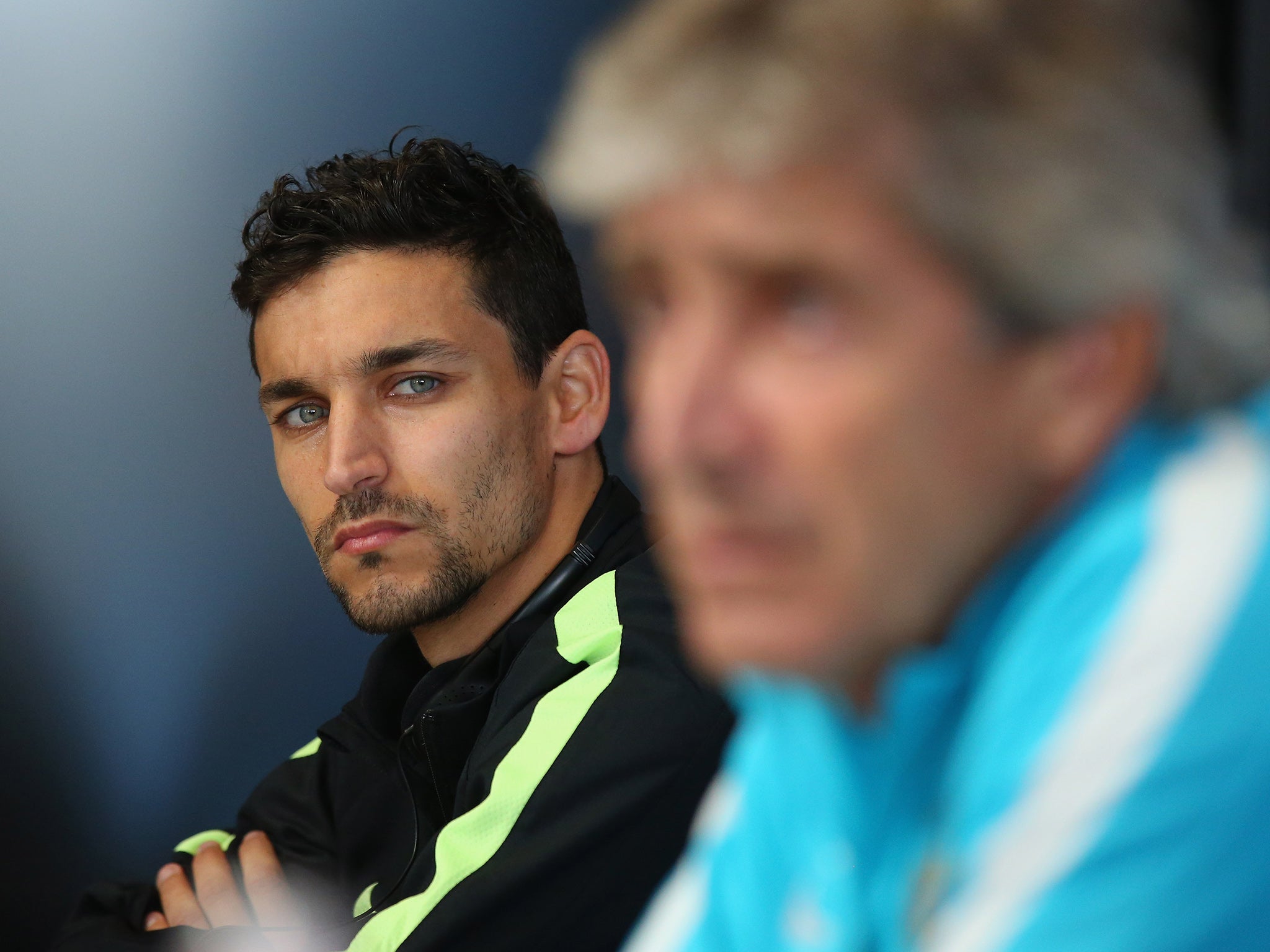 Jesus Navas and Manchester City manager Manuel Pellegrini address the media