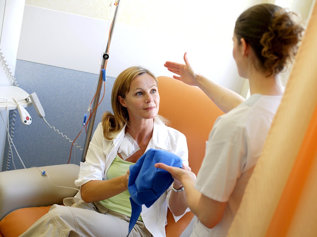 A nurse sets up a cooling treatment for a patient