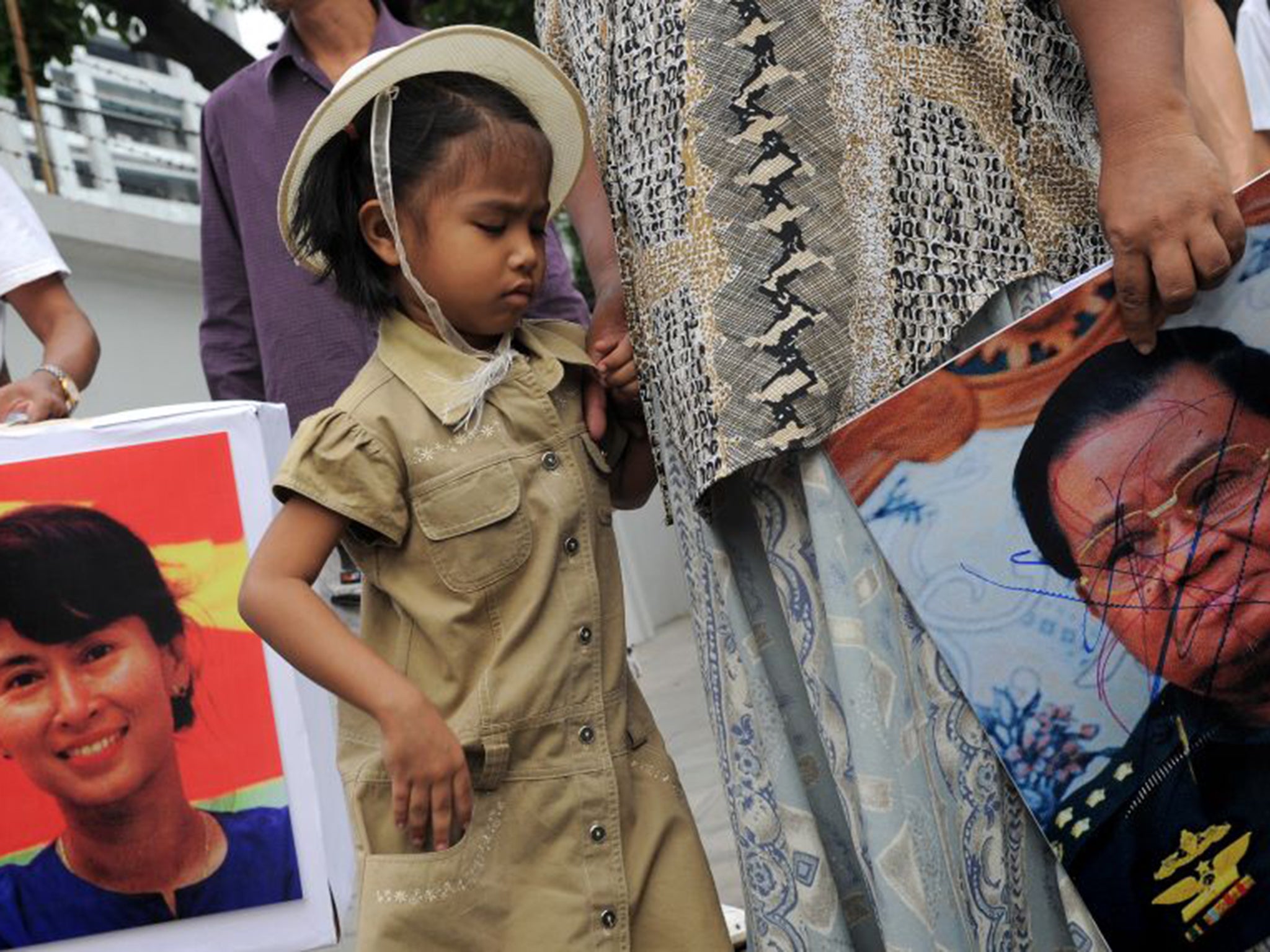 Protesters displaying images of the opposition leader Aung San Suu Kyi, left, and the former dictator Than Shwe, who is implicated in the jade trade