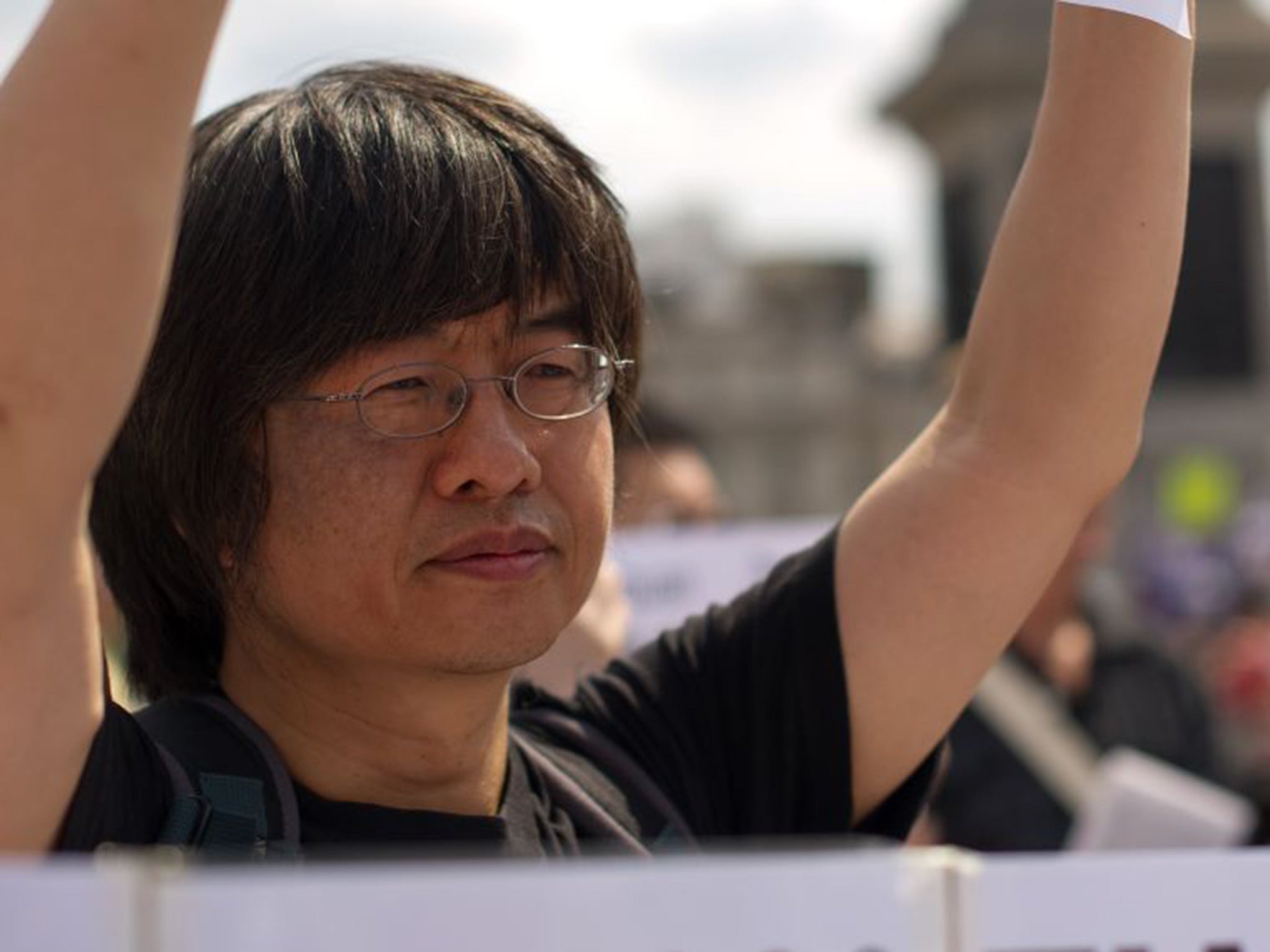 Tiananmen Square massacre survivor Shao Jiang holds a sign as a group gathers in Trafalgar Square