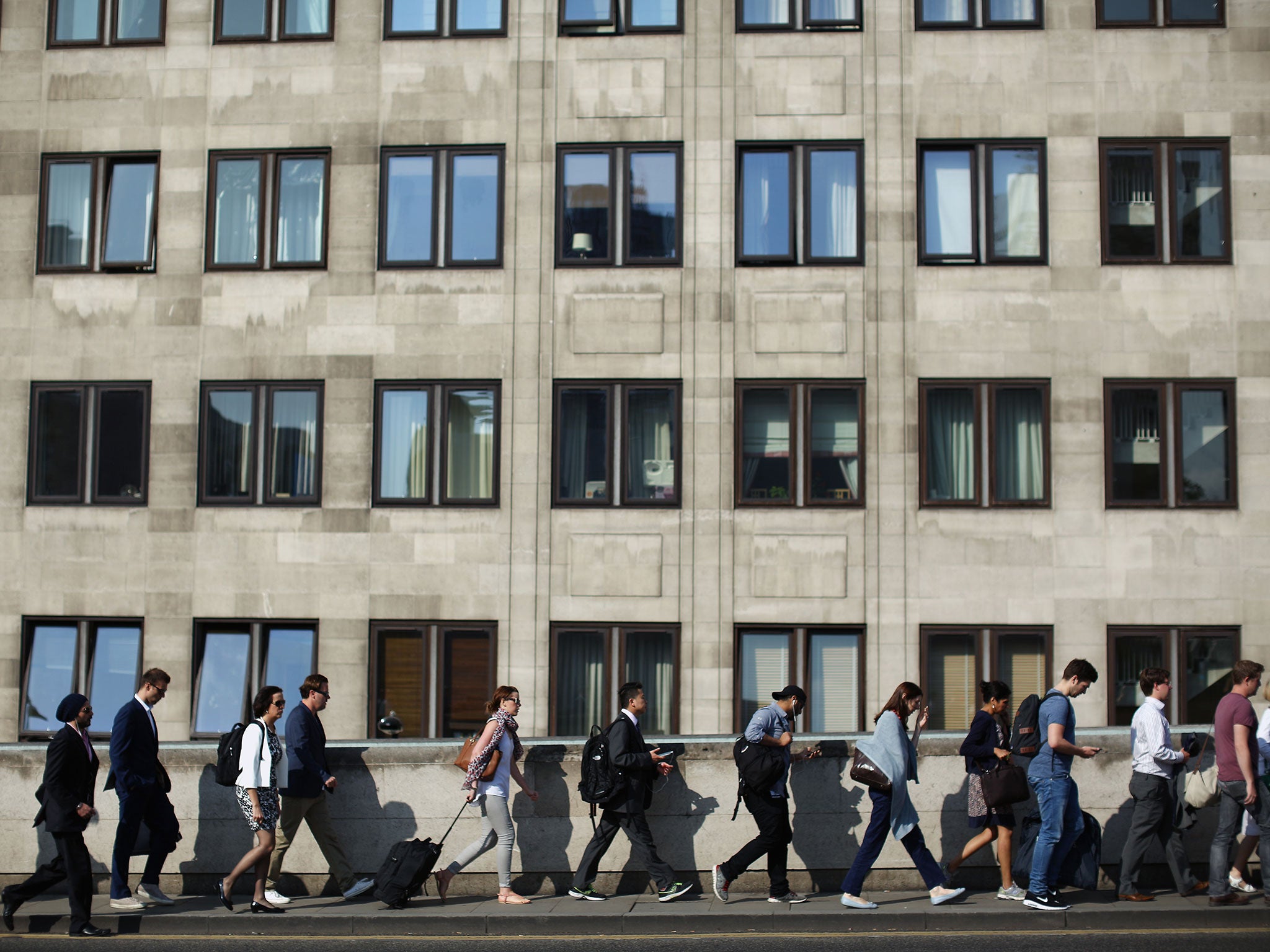 Commuters walk over Waterloo Bridge