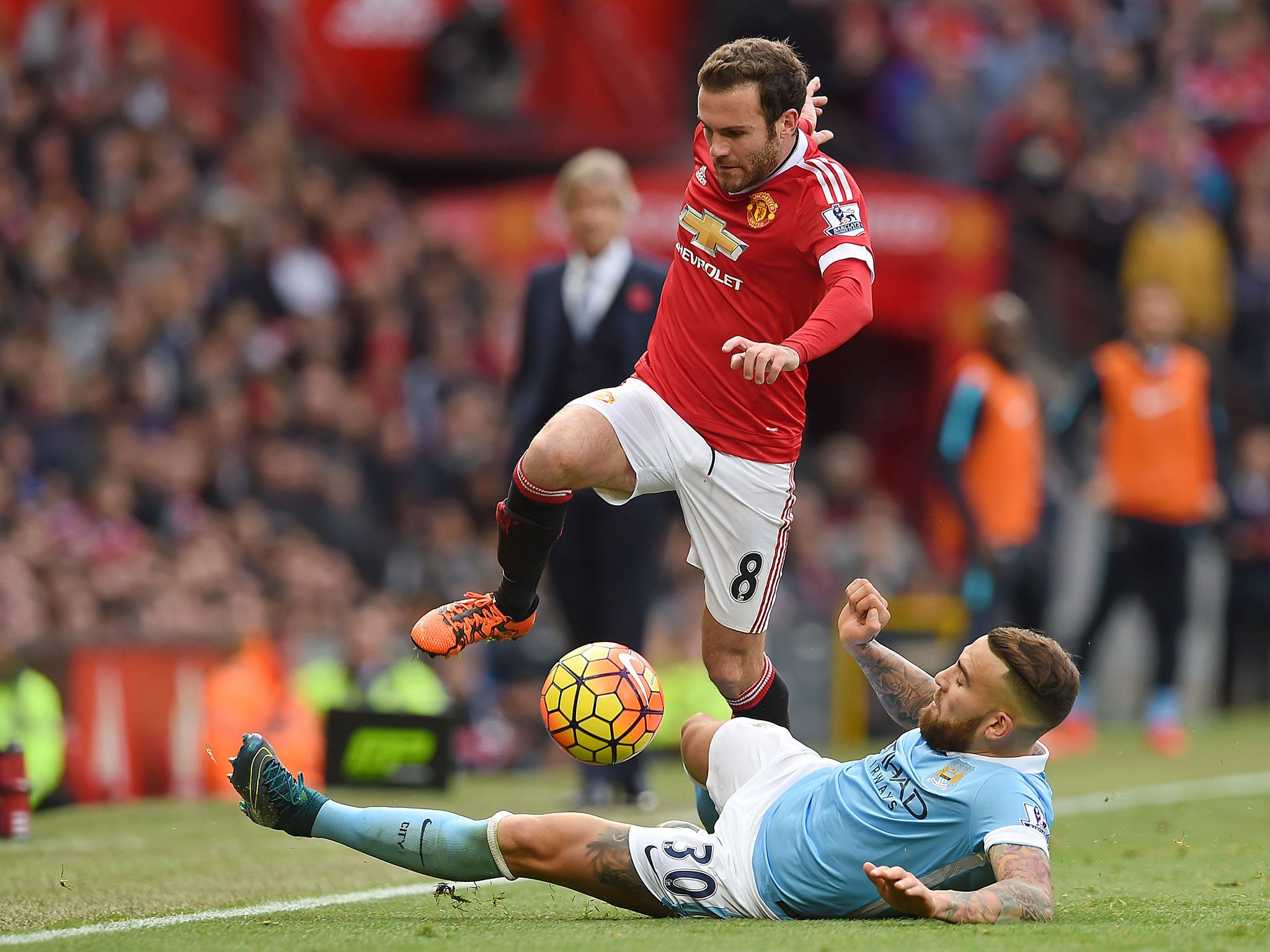 Manchester United midfielder Juan Mata evades a challenge from Manchester City's Nicolas Otamendi during Sunday's derby