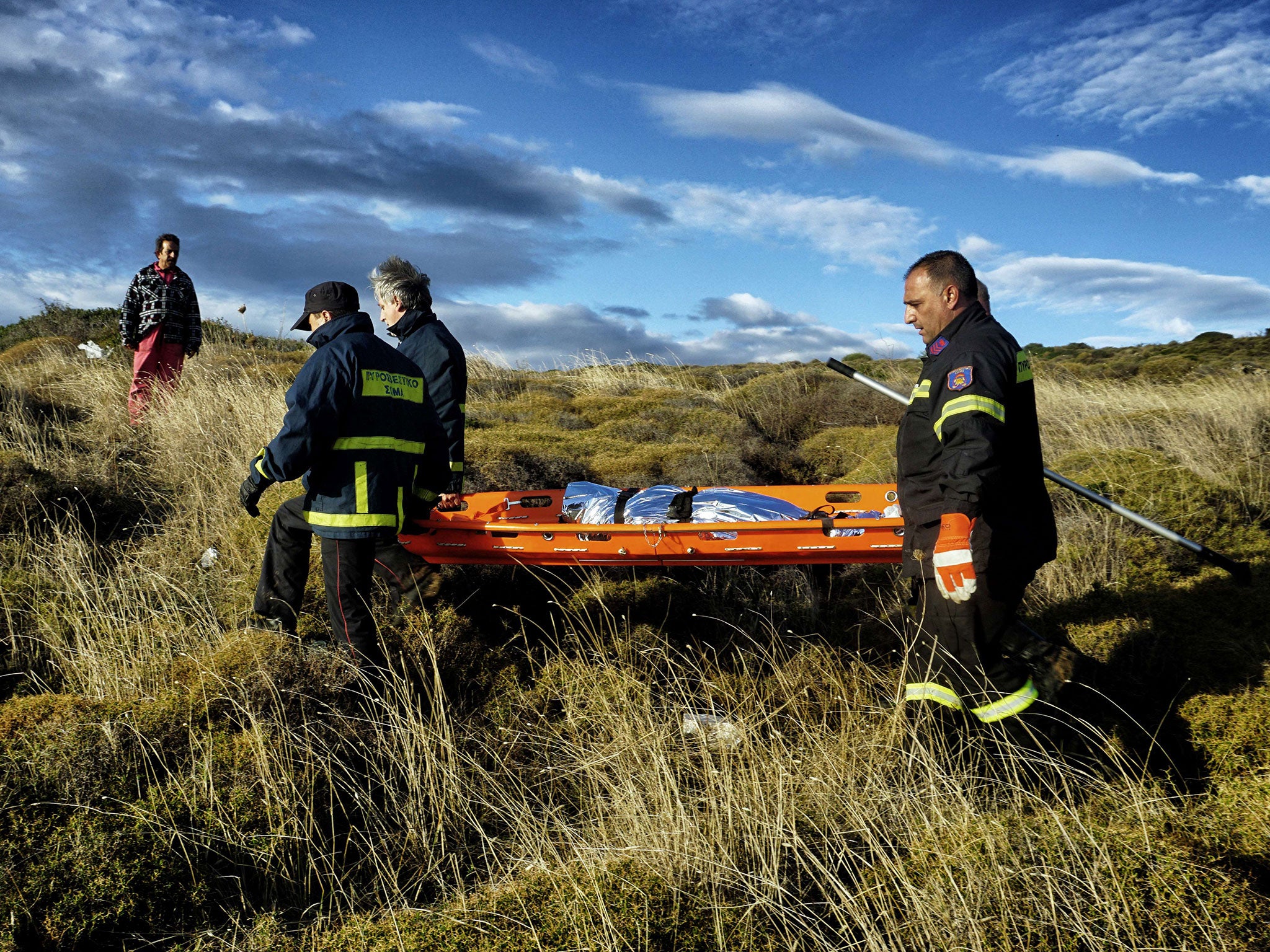 Firemen carry the body of a child after refugees arrived on the Greek island of Lesbos. Greek leaders were among those at the meeting in Brussels