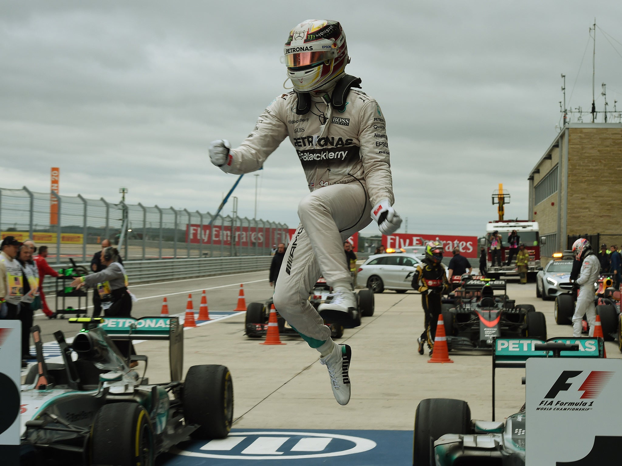 Hamilton leaps from his car in celebration