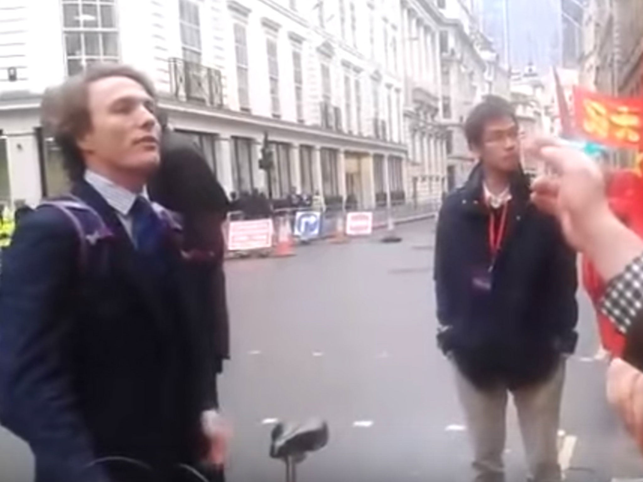 A still image from footage of Paul Powlesland challenging pro-China supporters at the Guildhall in London