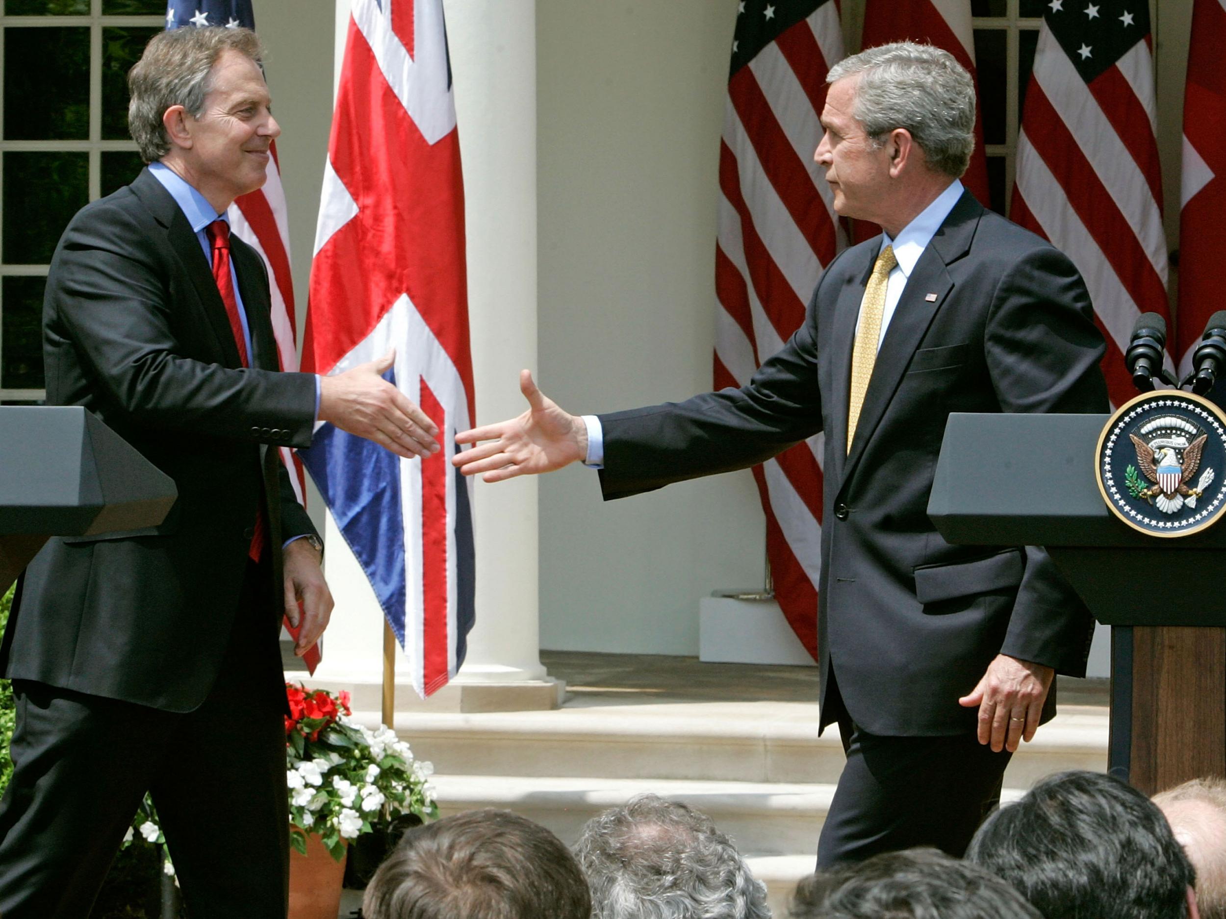 Tony Blair and George W. Bush shake hands after a news conference in 2007 Getty