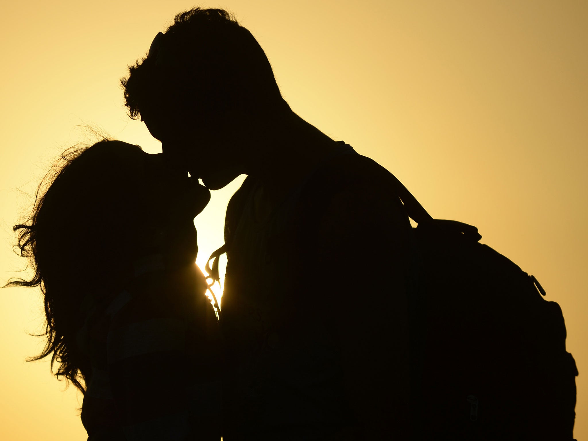 A couple kiss near the shore of El Yaque Beach, Venezuela