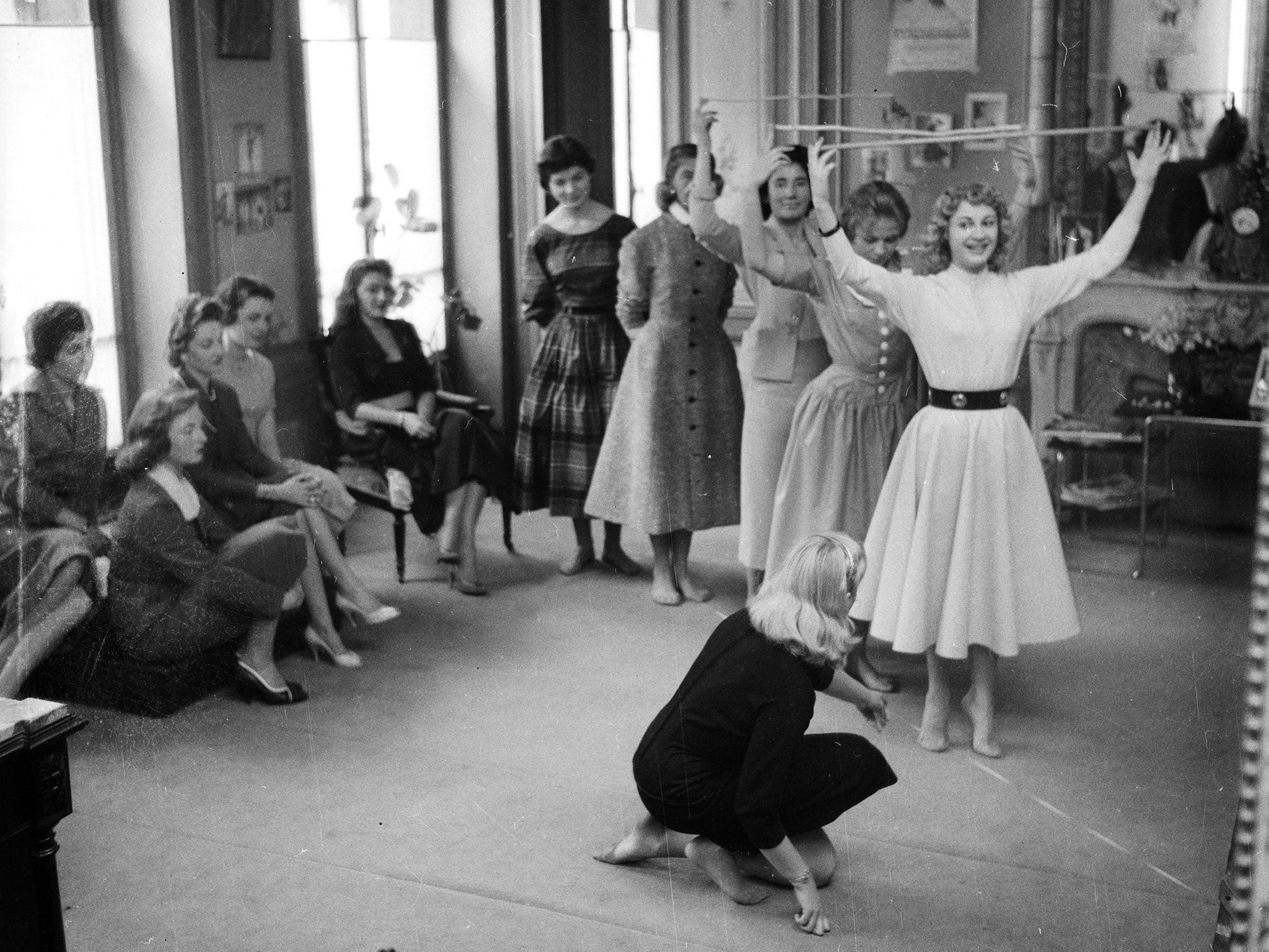 Models take part in a posture class in 1956