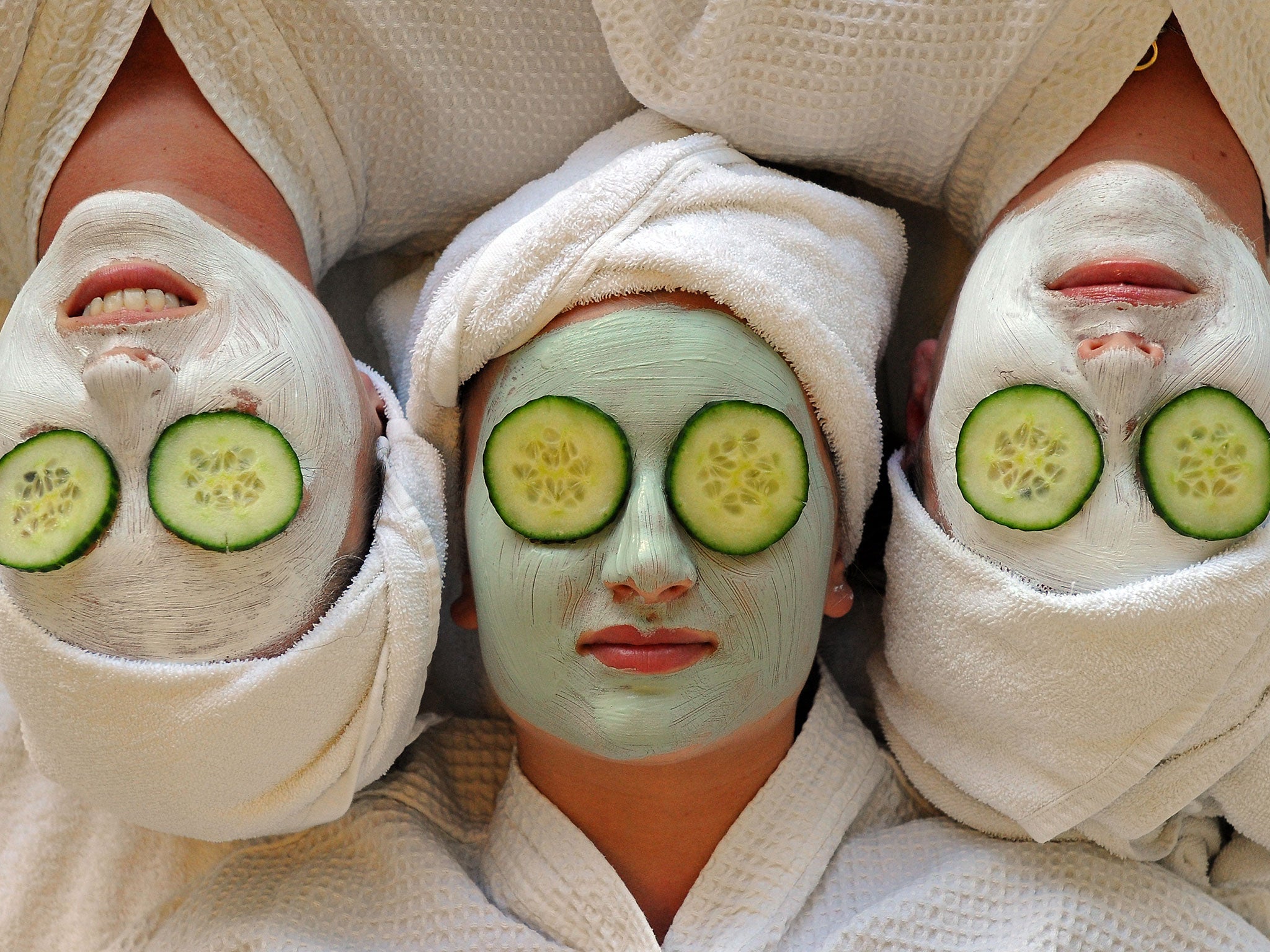 Women undergo facial beauty treatments at the spa