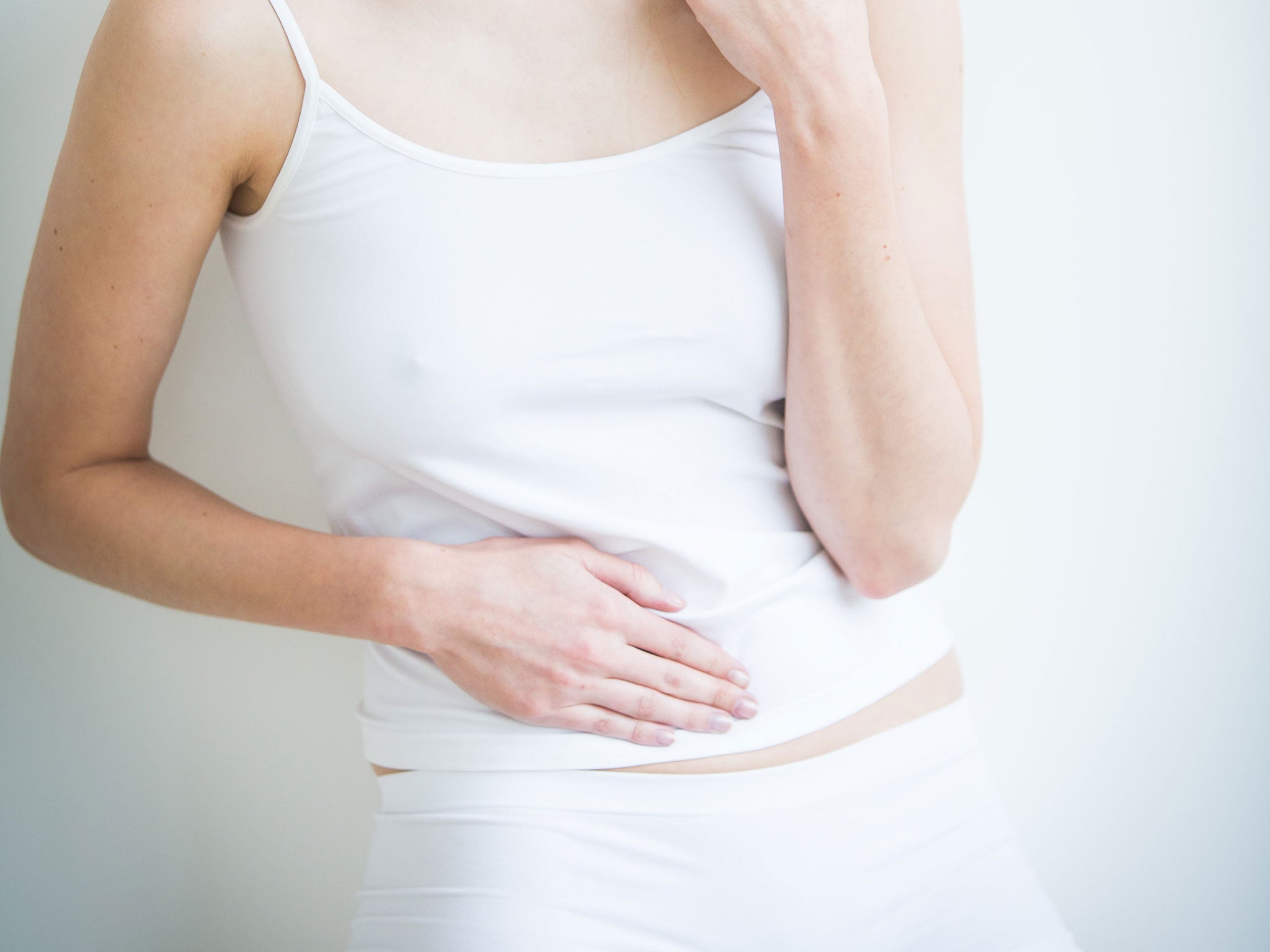 A woman holds her stomach