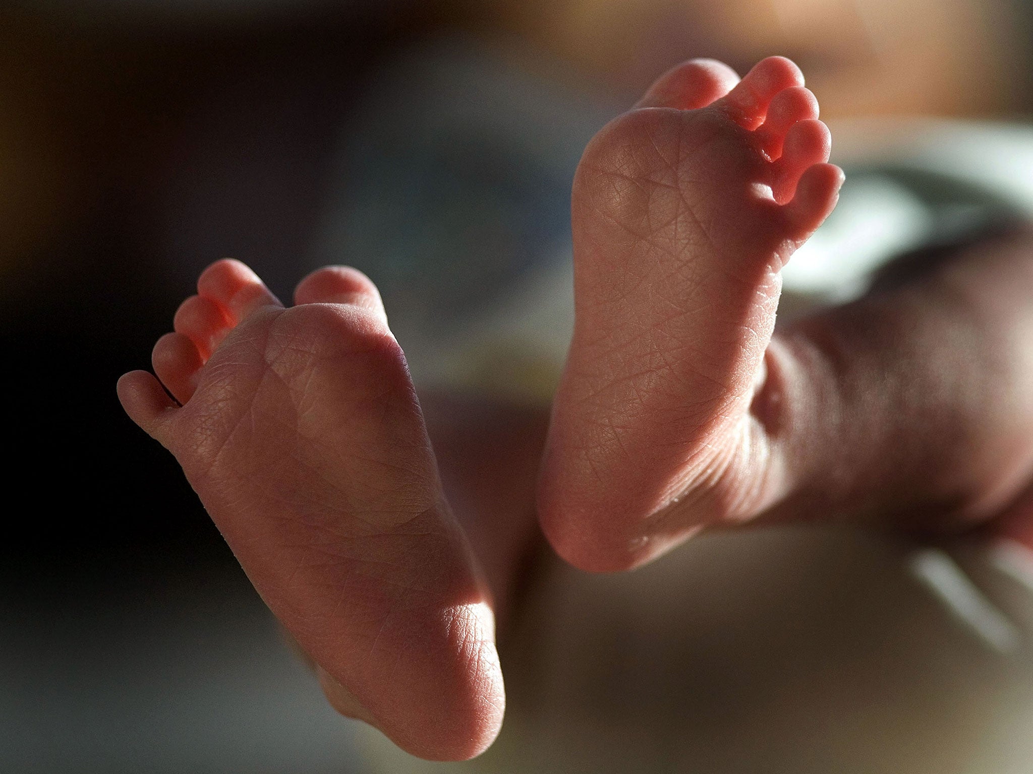 A two-week-old boy finds his feet in his new world.