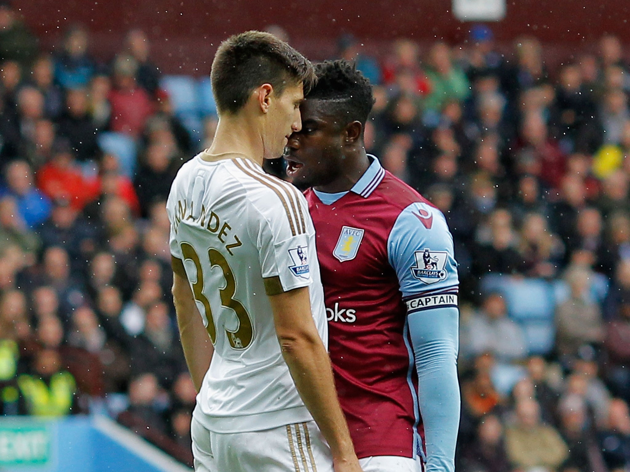 Aston Villa centre-back Micah Richards clashing with Swansea City's Federico Fernandez during the match on Saturday