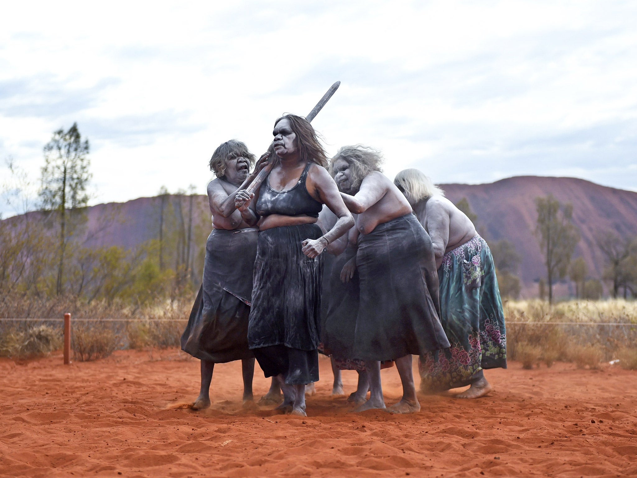 Aboriginal women perform traditional dances near Uluru to mark the 30th anniversary of the rock being handed back