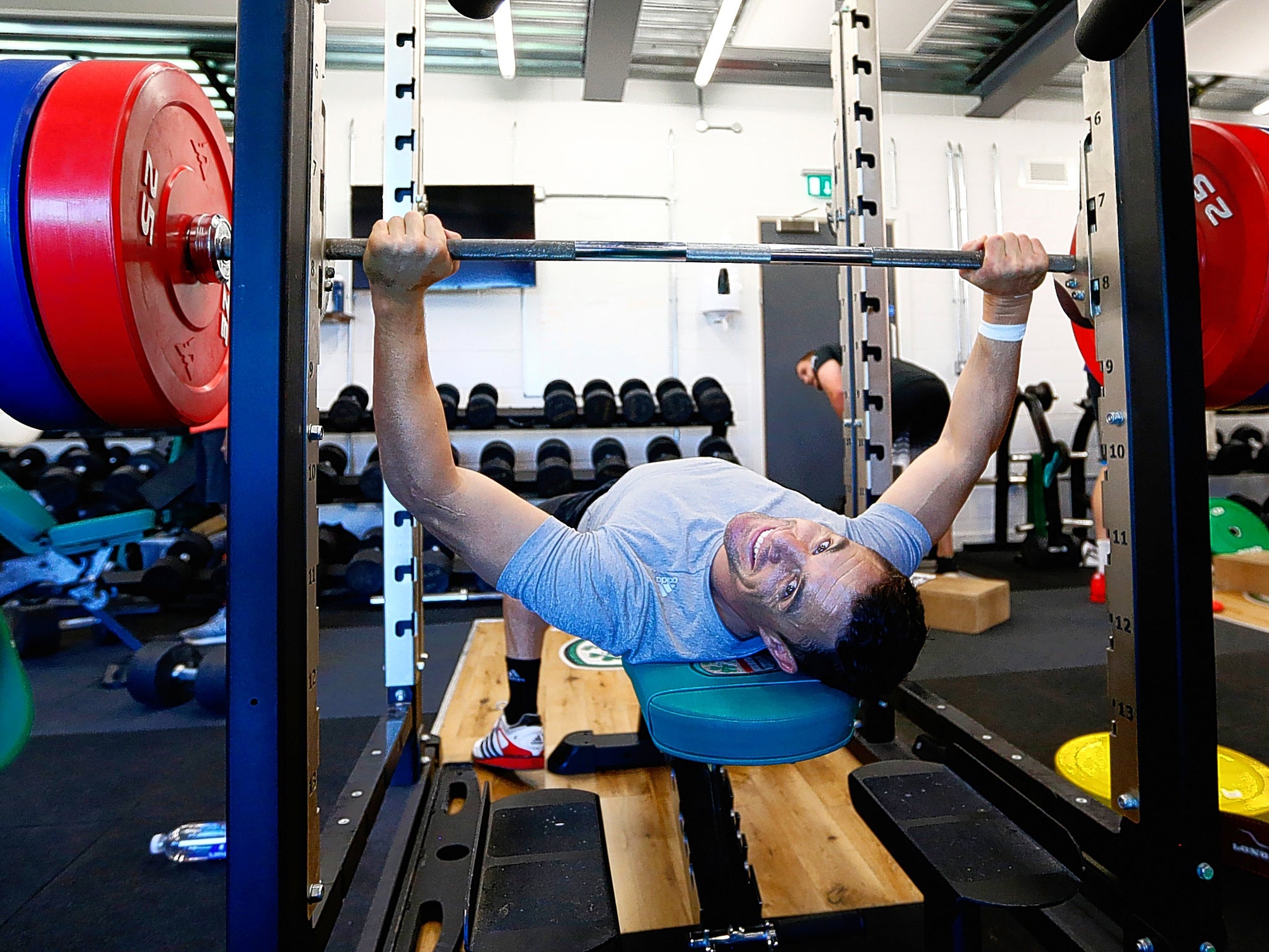 Daniel Carter trains on the bench press during an All Blacks session in Bagshot