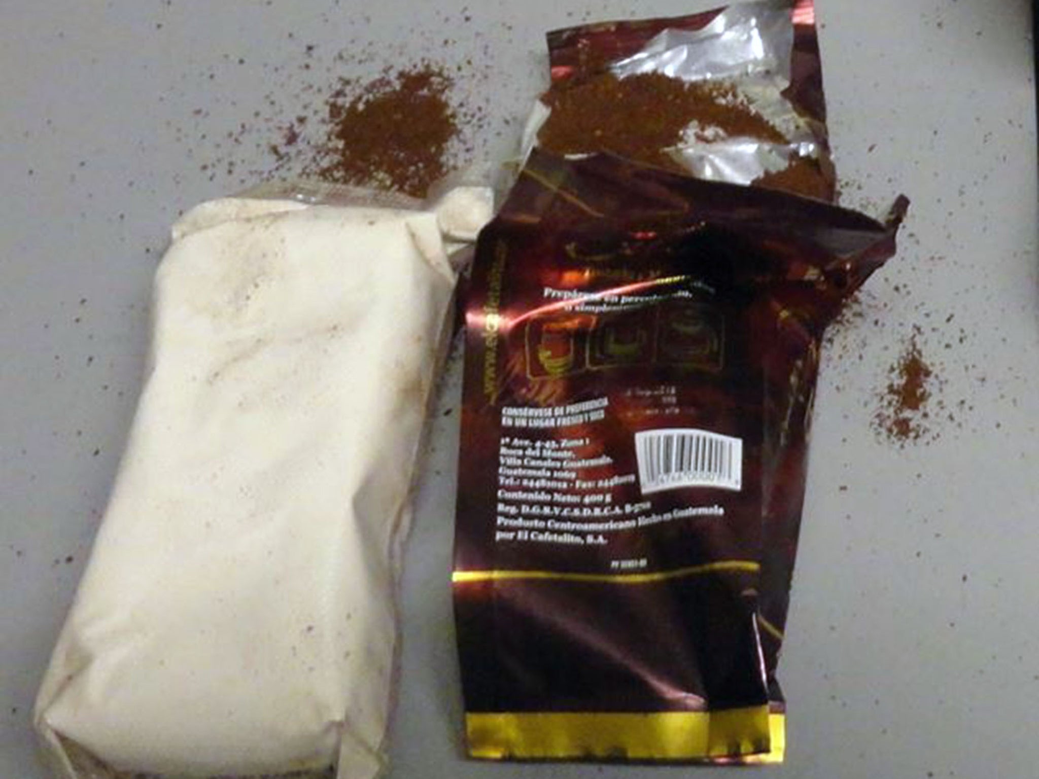 This October 2015 photo provided by U.S. Customs and Border Protection shows a packet of cocaine hidden in a bag of ground coffee in Miami. Three bags of roasted, ground coffee arriving at Miami International Airport in a package from Guatemala in October were actually filled with more than 3 pounds of heroin, customs officials said.