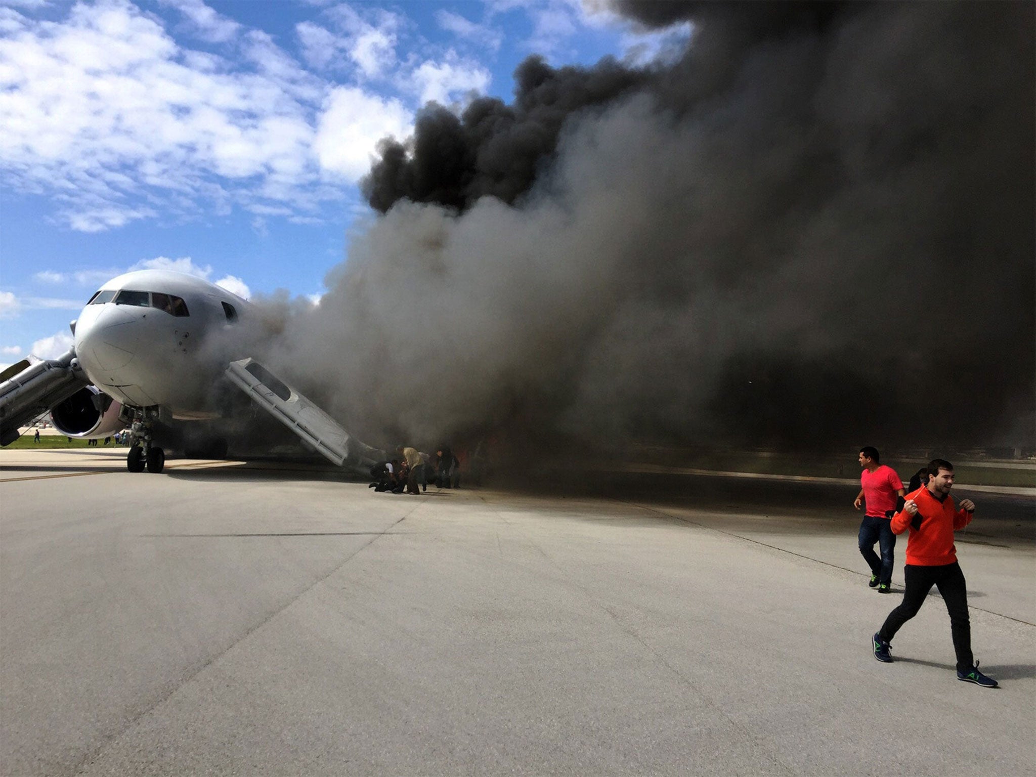 Thick plumes of black smoke were seen coming from the aircraft on the runway