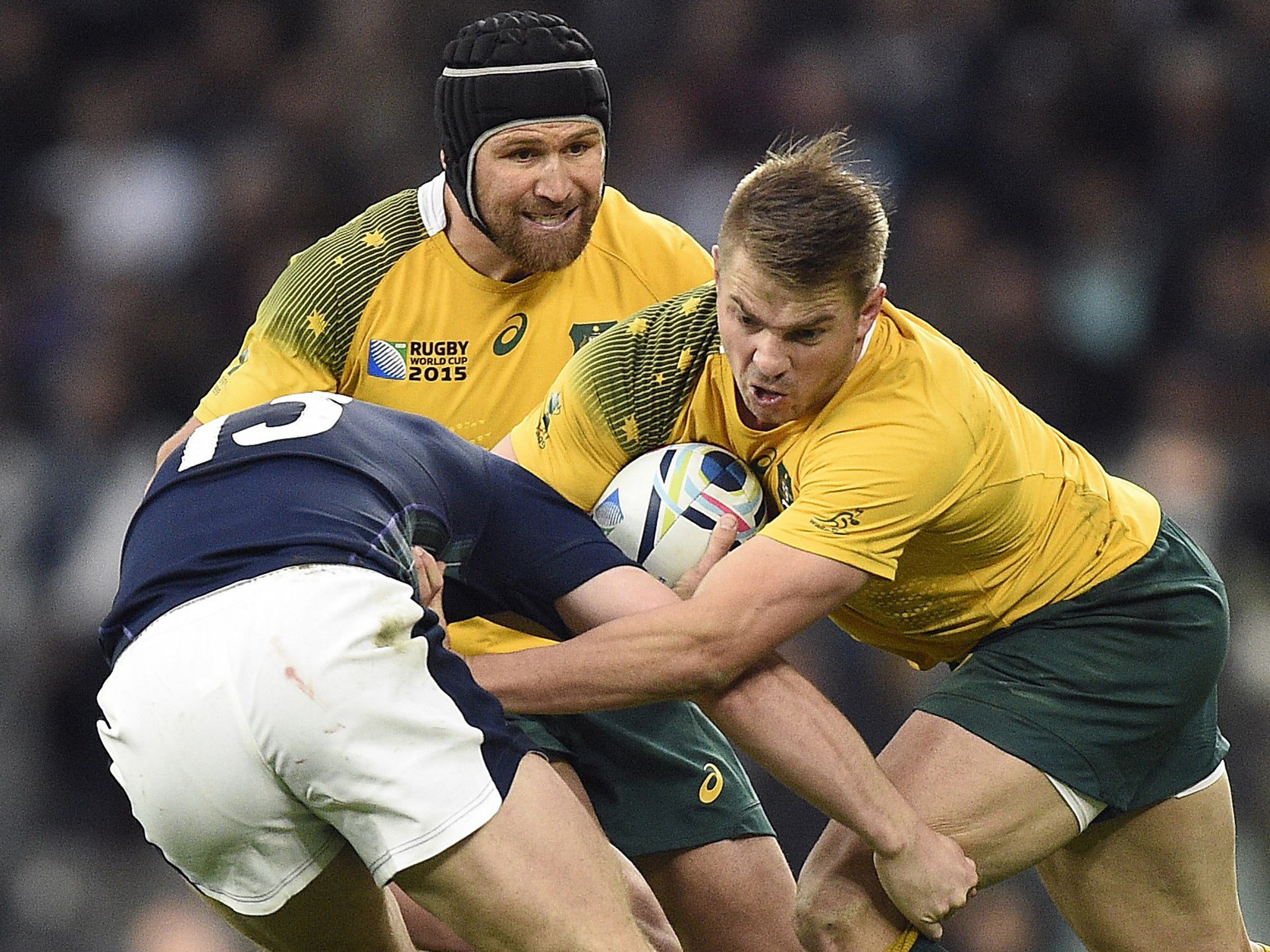 Australia's Matt Giteau, left, and Drew Mitchell in action against Scotland