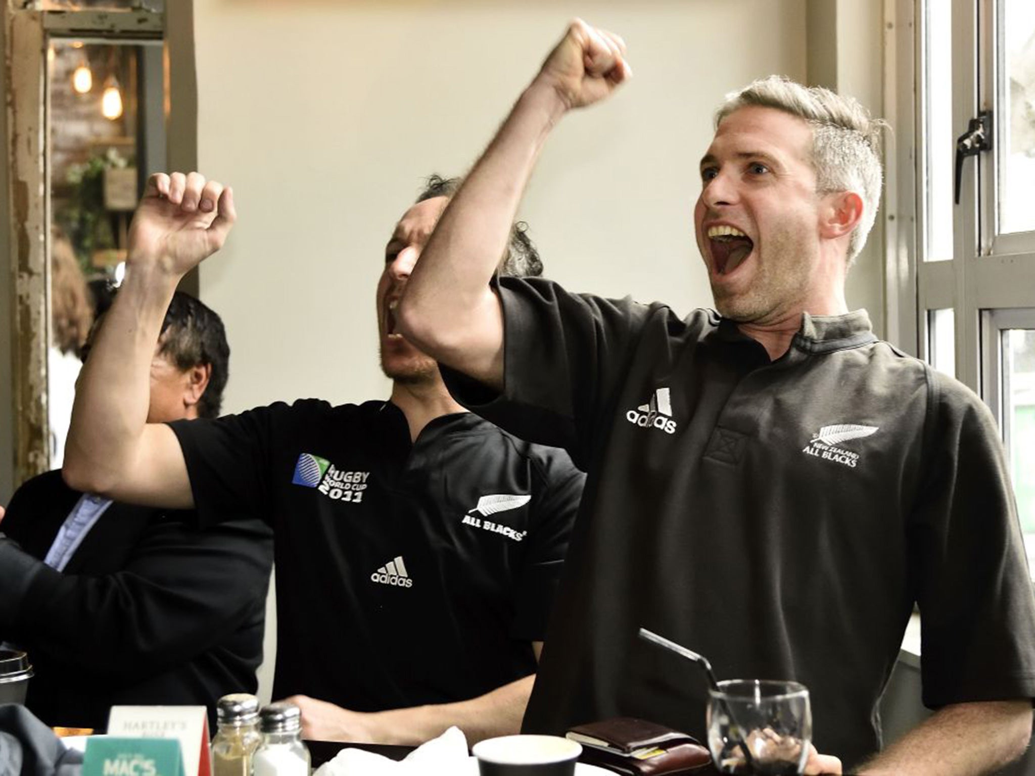 New Zealand fans celebrate a try as they their team beating France in the quarter-finals