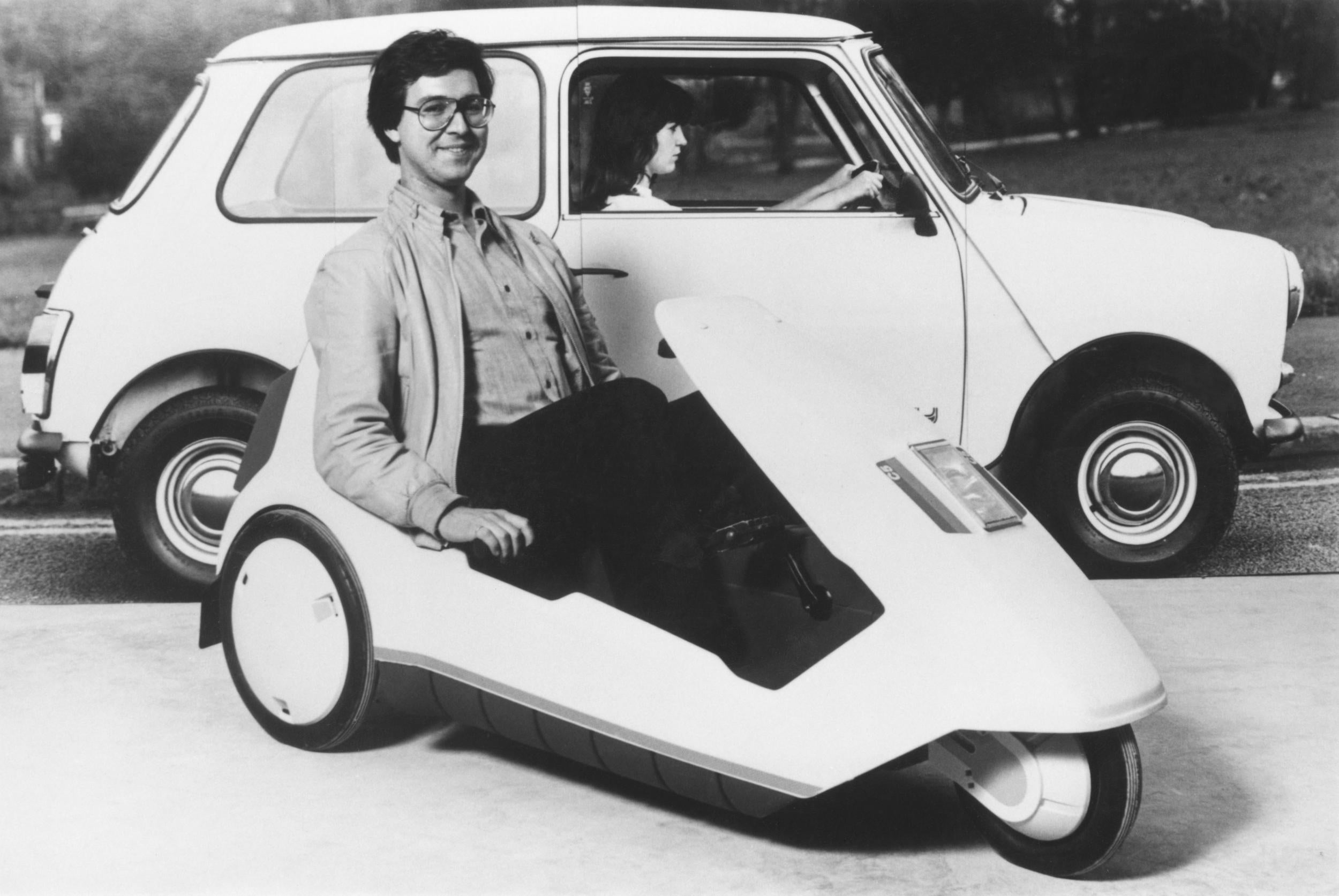 A driver demonstrates a miniature electric car, in 1985