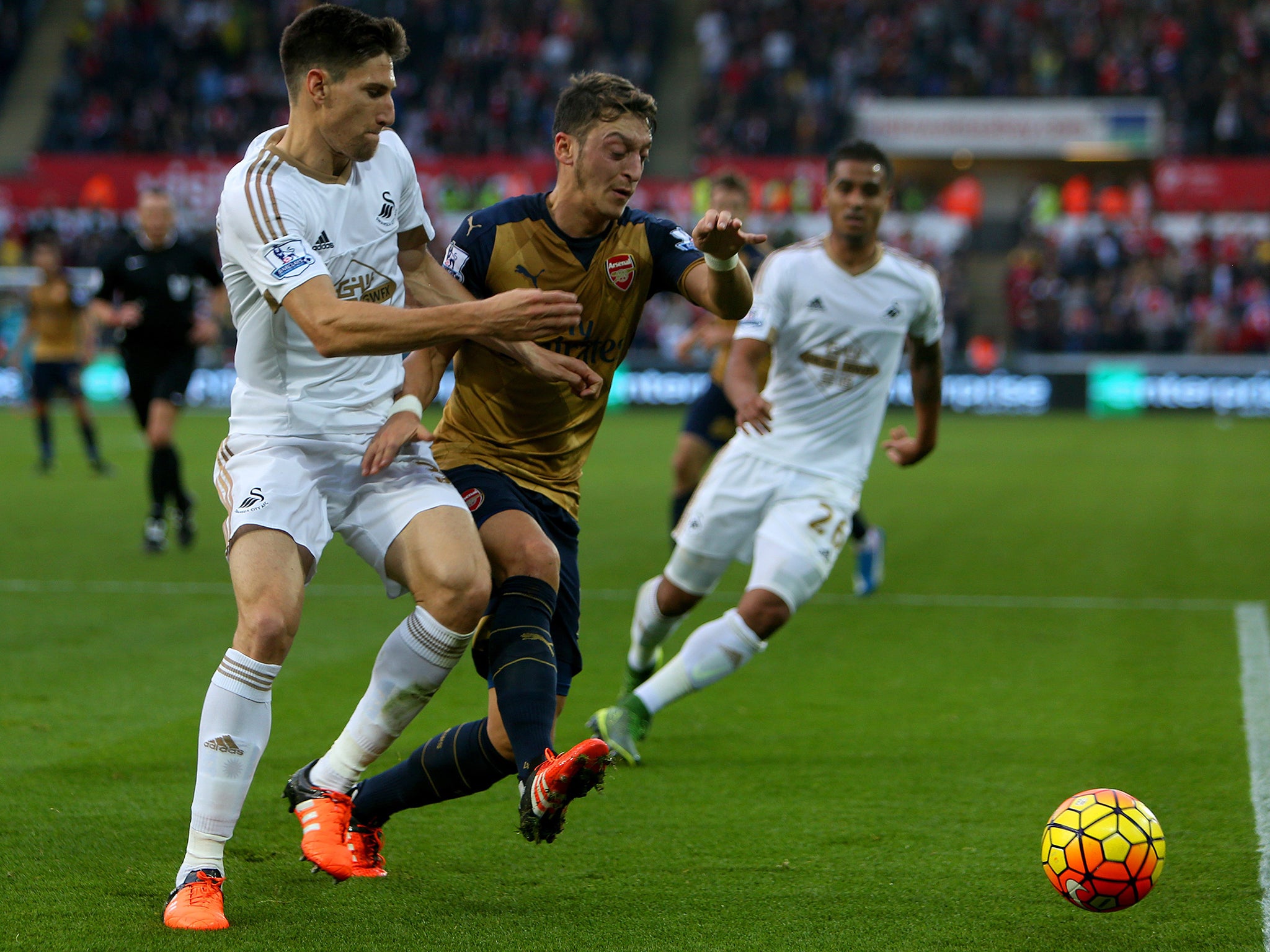 Mesut Ozil in action for Arsenal against Swansea