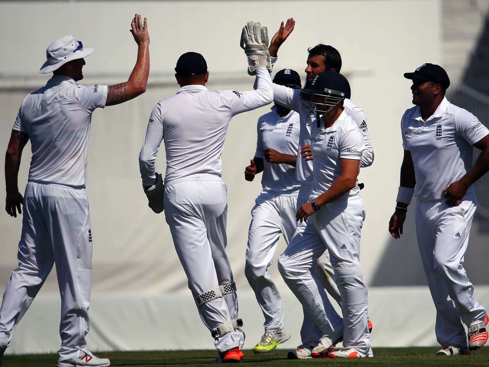 Moeen Ali celebrates with his England team-mates after taking the wicket of Mohammad Hafeez