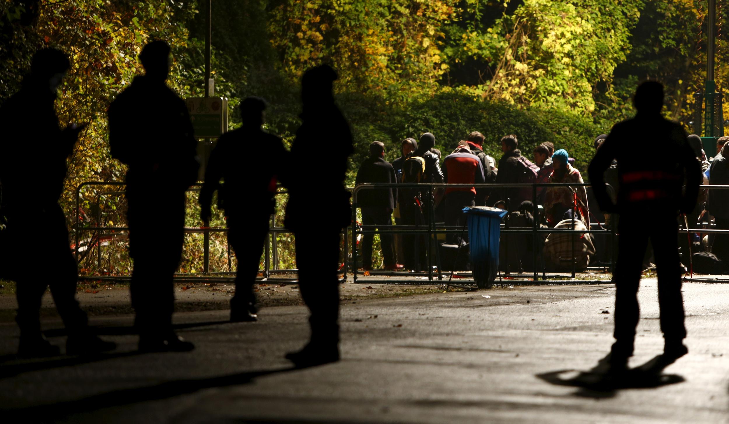 Refugees wait at the Austrian-German border in Achleiten