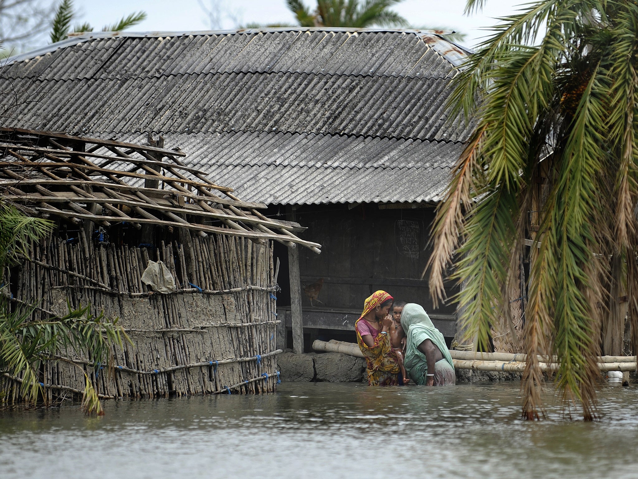 Bangladeshi villagers after a cyclone hit in 2009; women may be unable to swim and hampered by long clothes