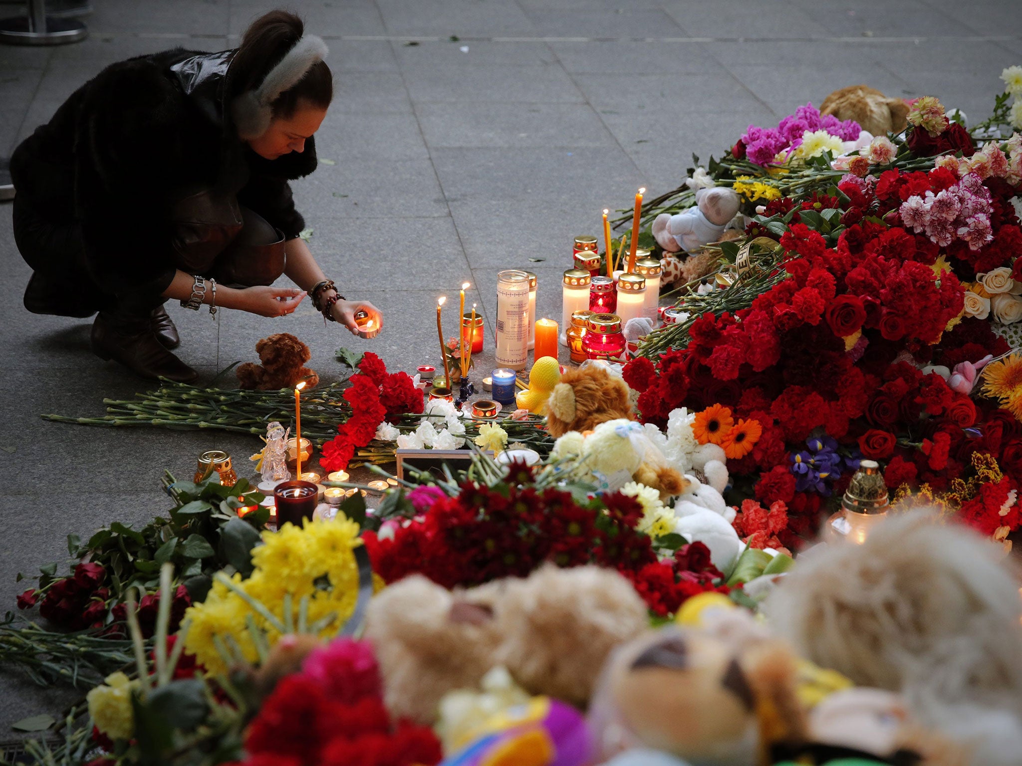 Russian people lay flowers and light candles to memory of victims at Pulkovo airport in St Petersburg