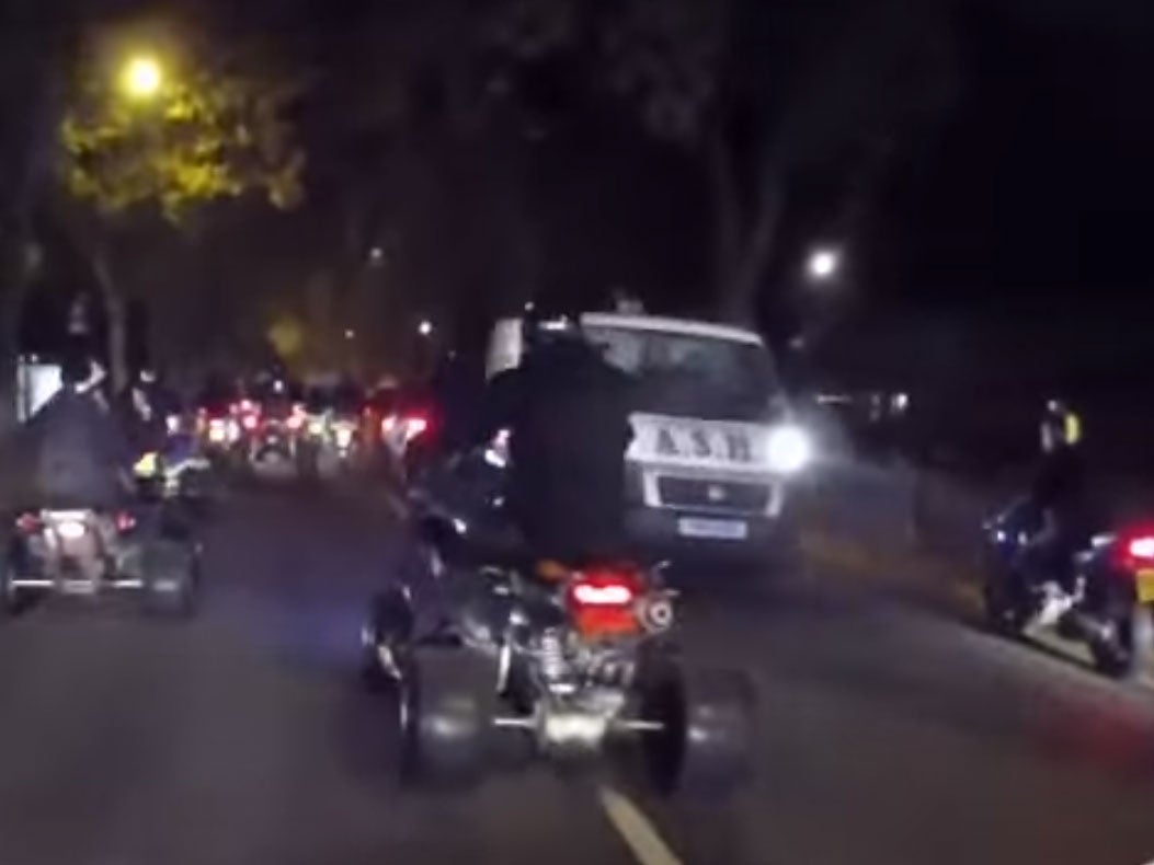 Footage showing bikers riding either side of an oncoming van during the Hallowe'en rideout