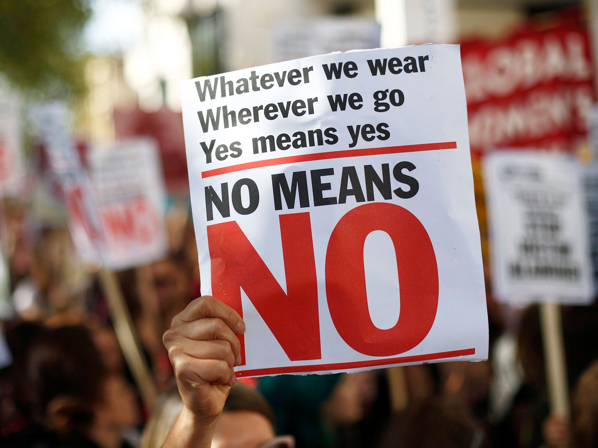 A woman holds a banner as she takes part in a 'slut walk' protest calling for sexual violence against women to be taken more seriously