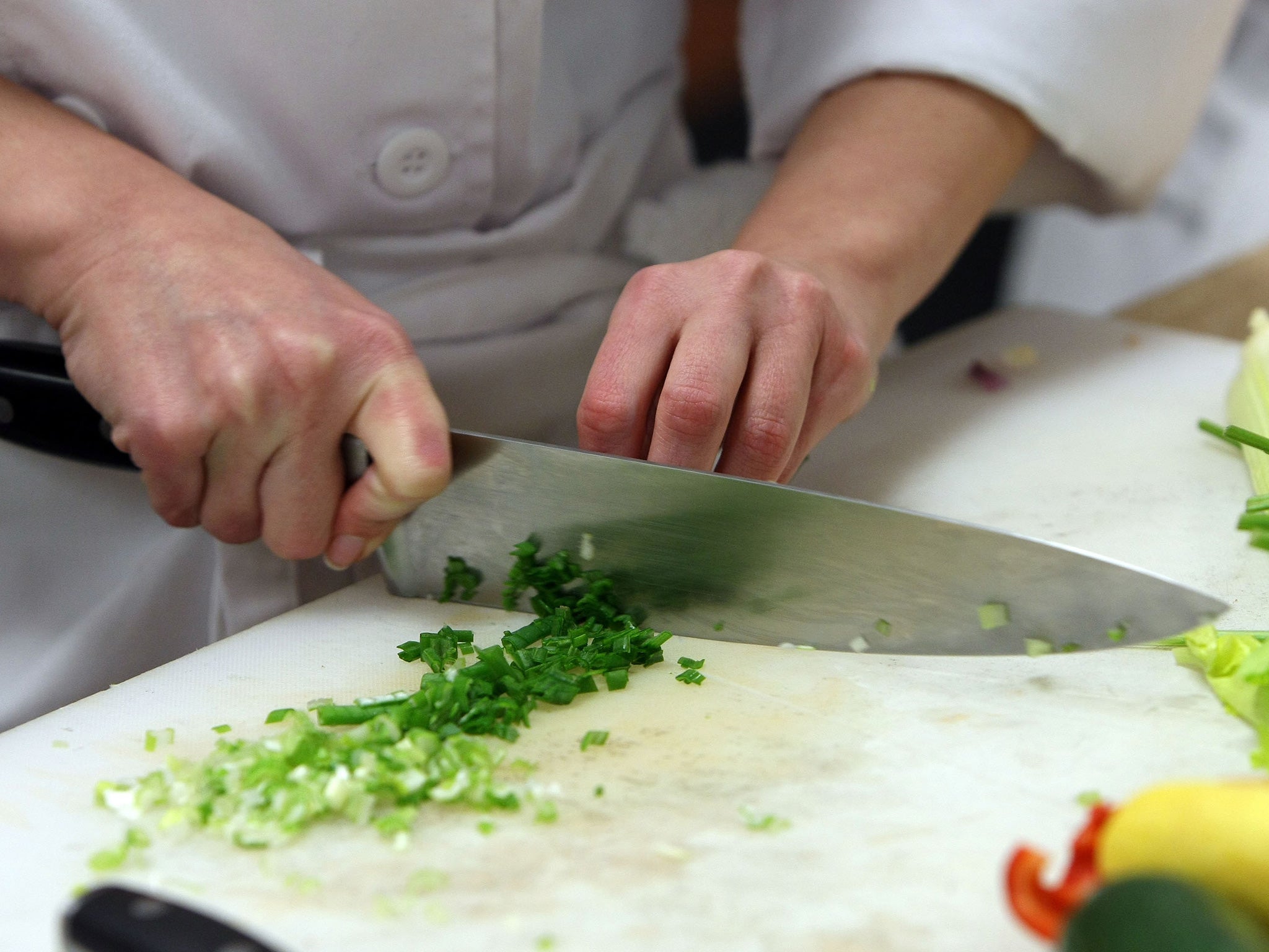 A chef chops herbs