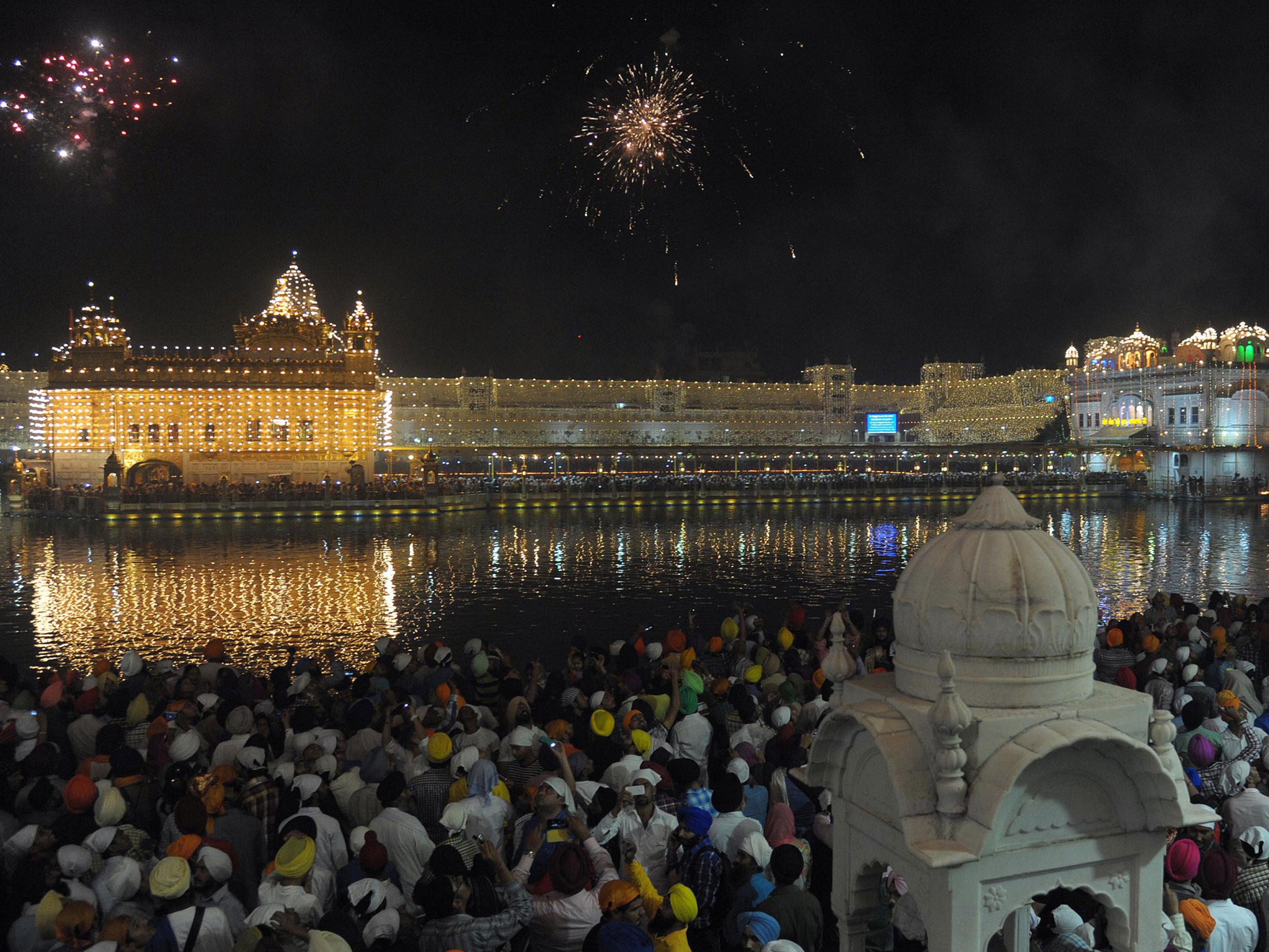 Indian Sikhs watch fireworks on Diwali at the illuminated Golden Temple in Amritsar, India Getty