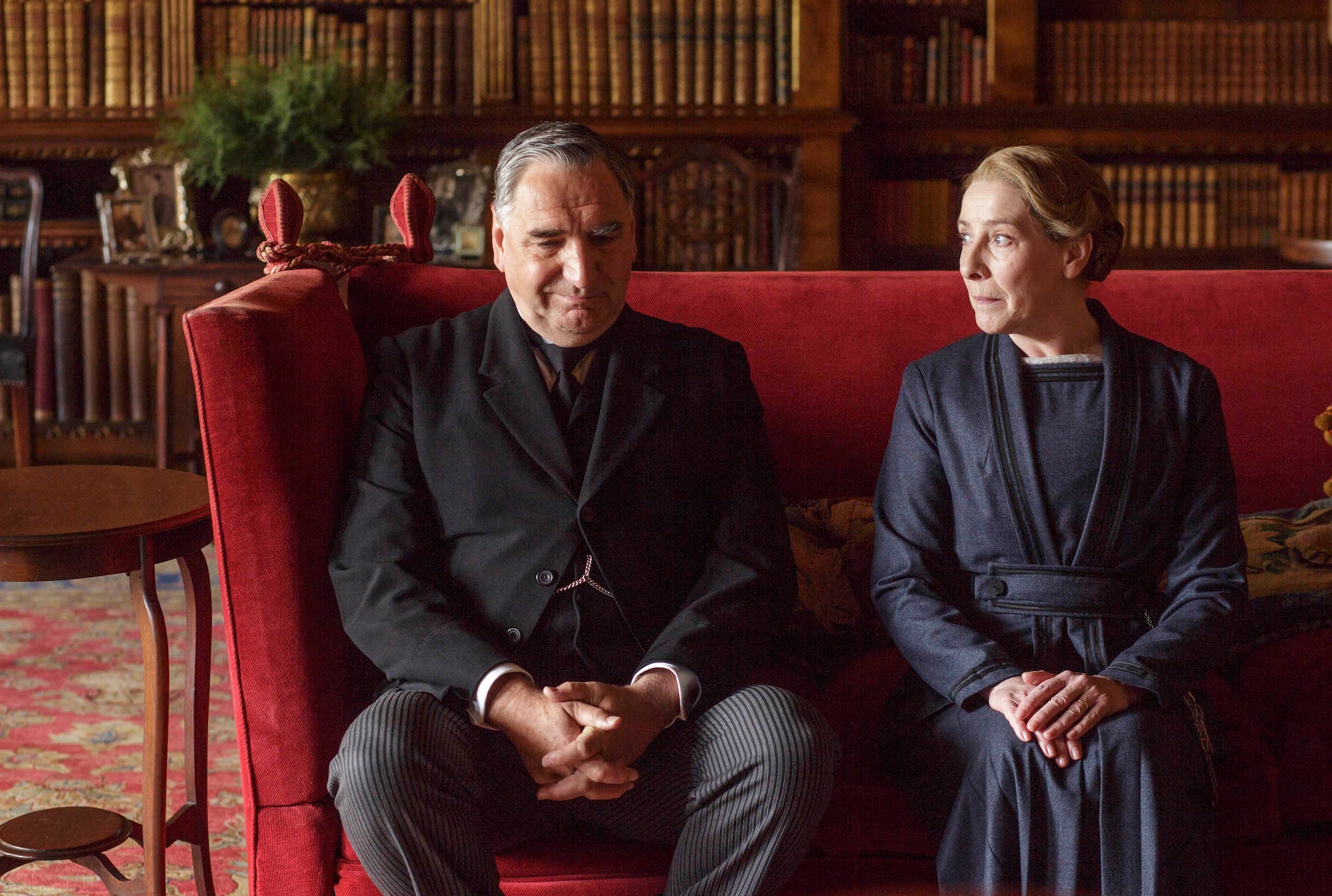 Mr Carson and Mrs Hughes test out the upstairs sofa in Downton Abbey