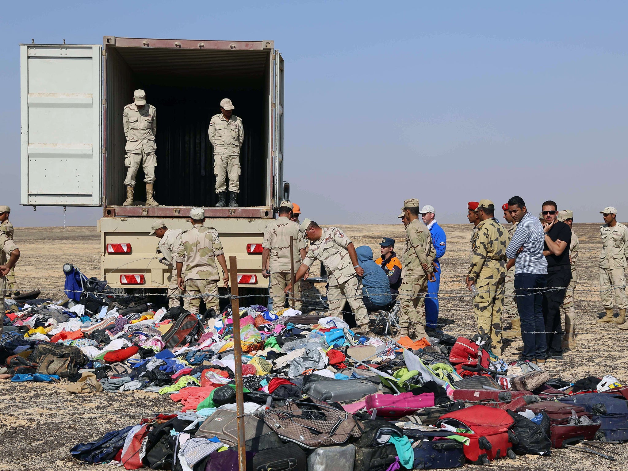 Russian emergency services personnel and Egyptian servicemen working at the crash site of a A321 Russian airliner in Wadi al-Zolomat, a mountainous area of Egypt's Sinai Peninsula