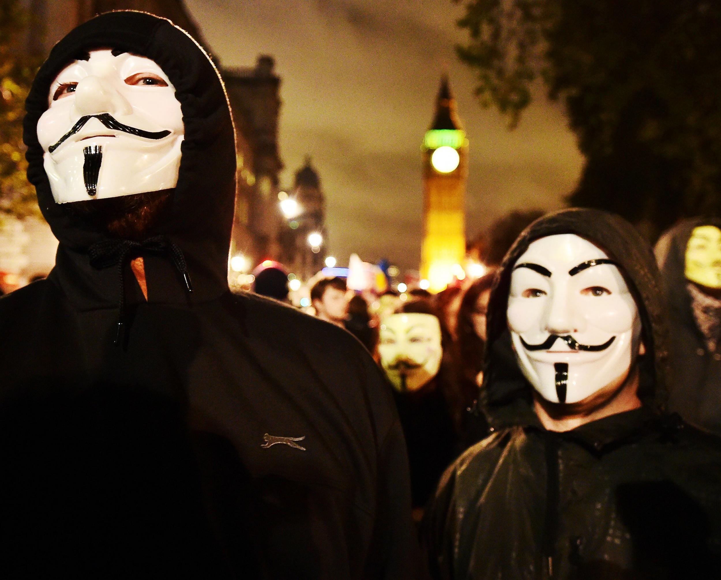 Two protesters in the "Guido" masks at the rally