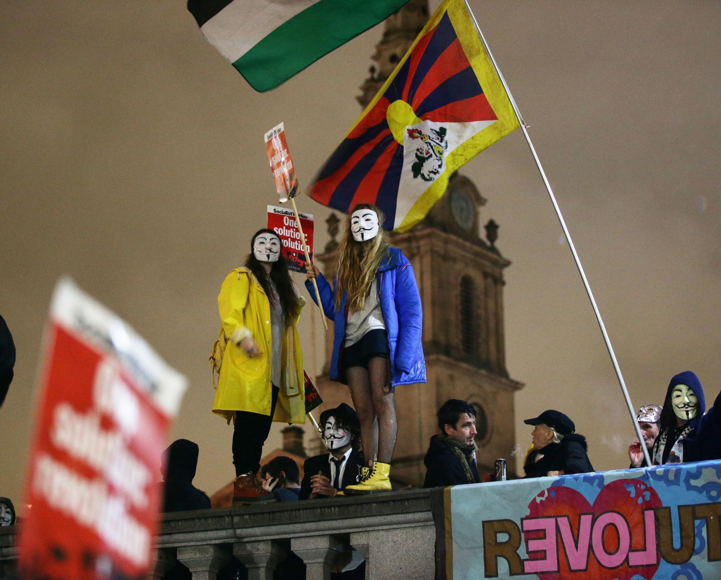 Female protesters waving flags at the rally which started in Trafalgar Square