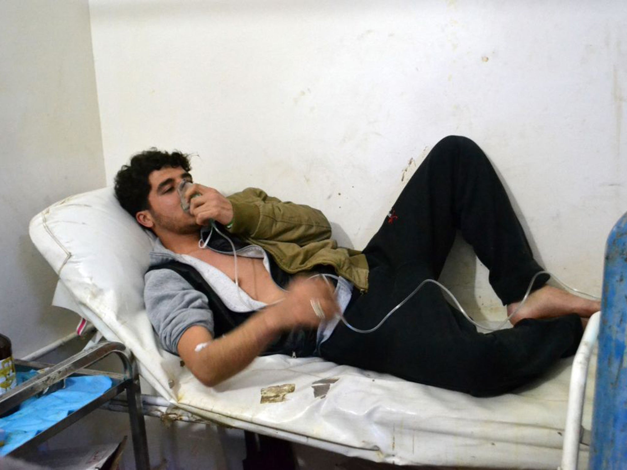 A man breathes with aid of an oxygen mask following a mustard gas attack in Idlib, Syria