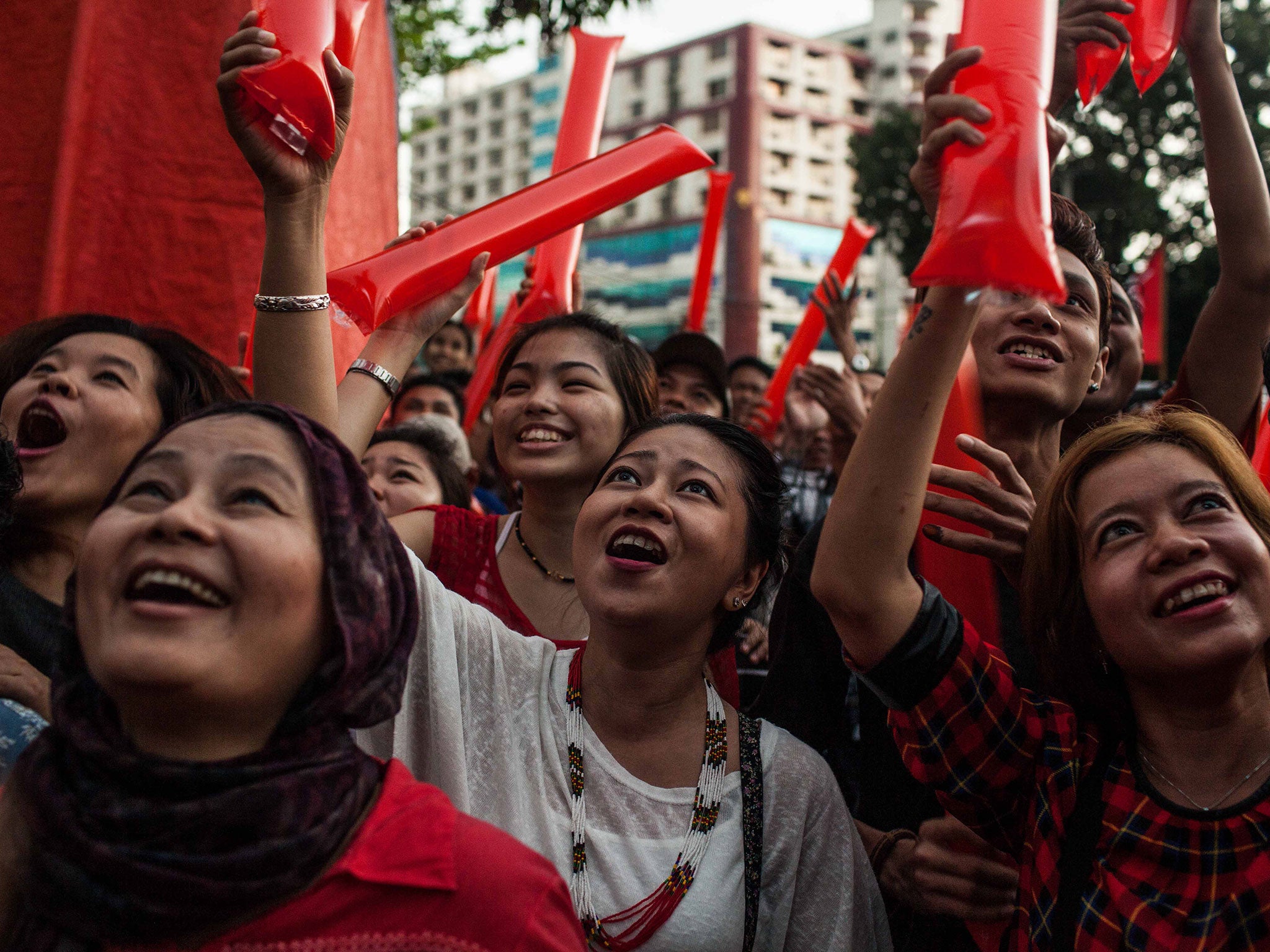 Supporters cheer as they wait for results at a National League for Democracy rally in Rangoon