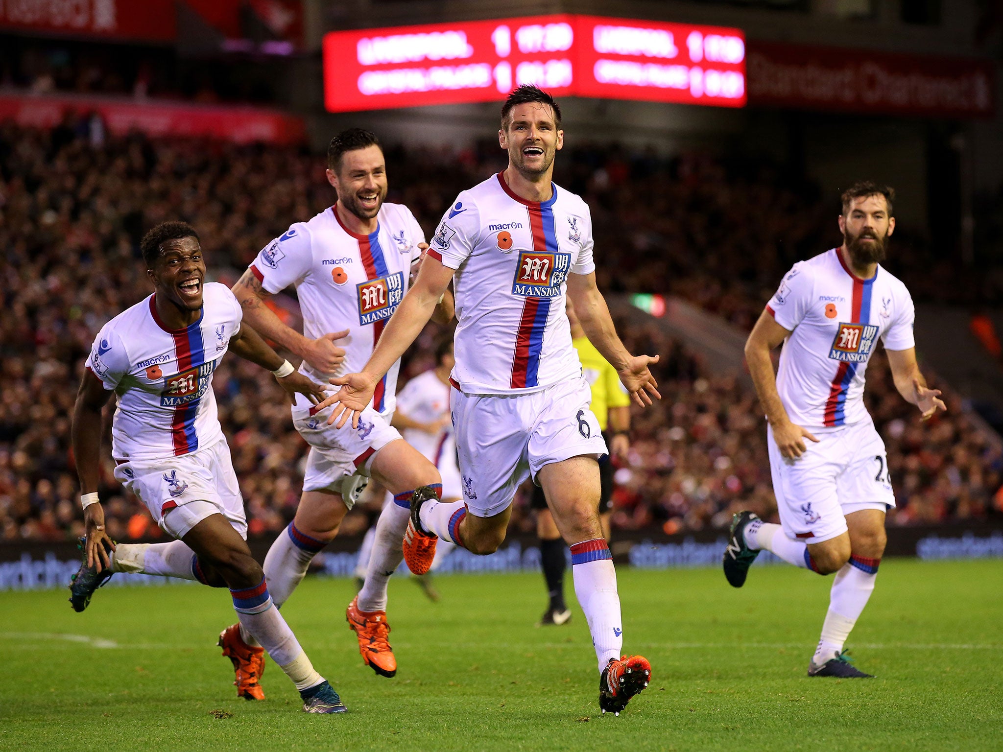 Scott Dann, centre, celebrates his winner at Anfield