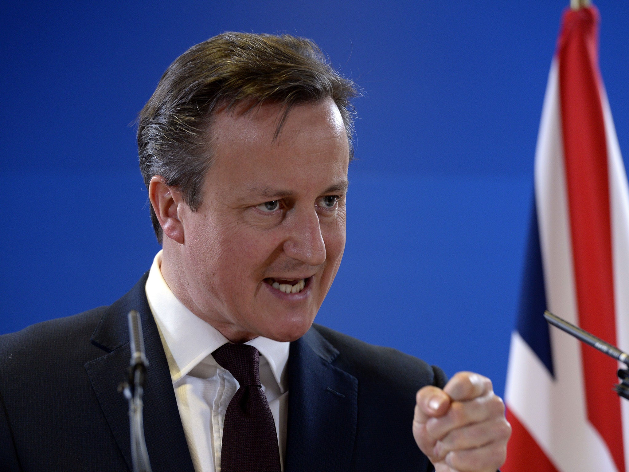 British Prime Minister David Cameron talks to the media at the end of a European Union Summit held at the EU Council building in Brussels