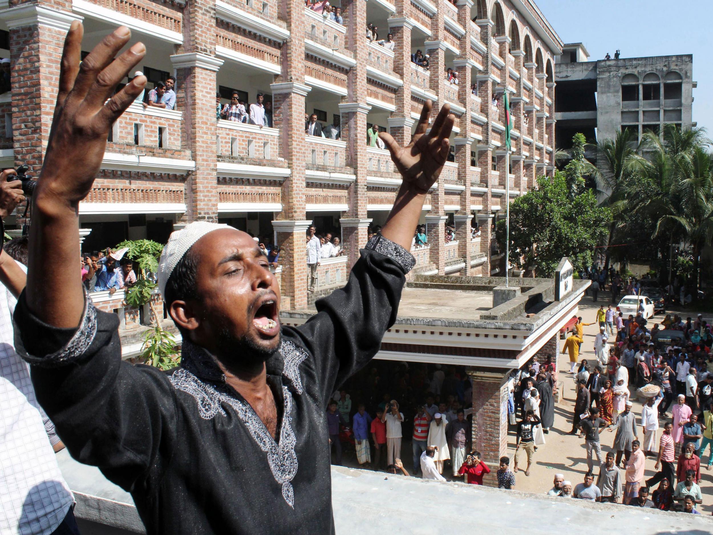 &#13;
The father of Samiul Alam Rajon, a 13-year-old boy who was murdered in July, reacts on the court premises after the sentencing of his son's killers&#13;