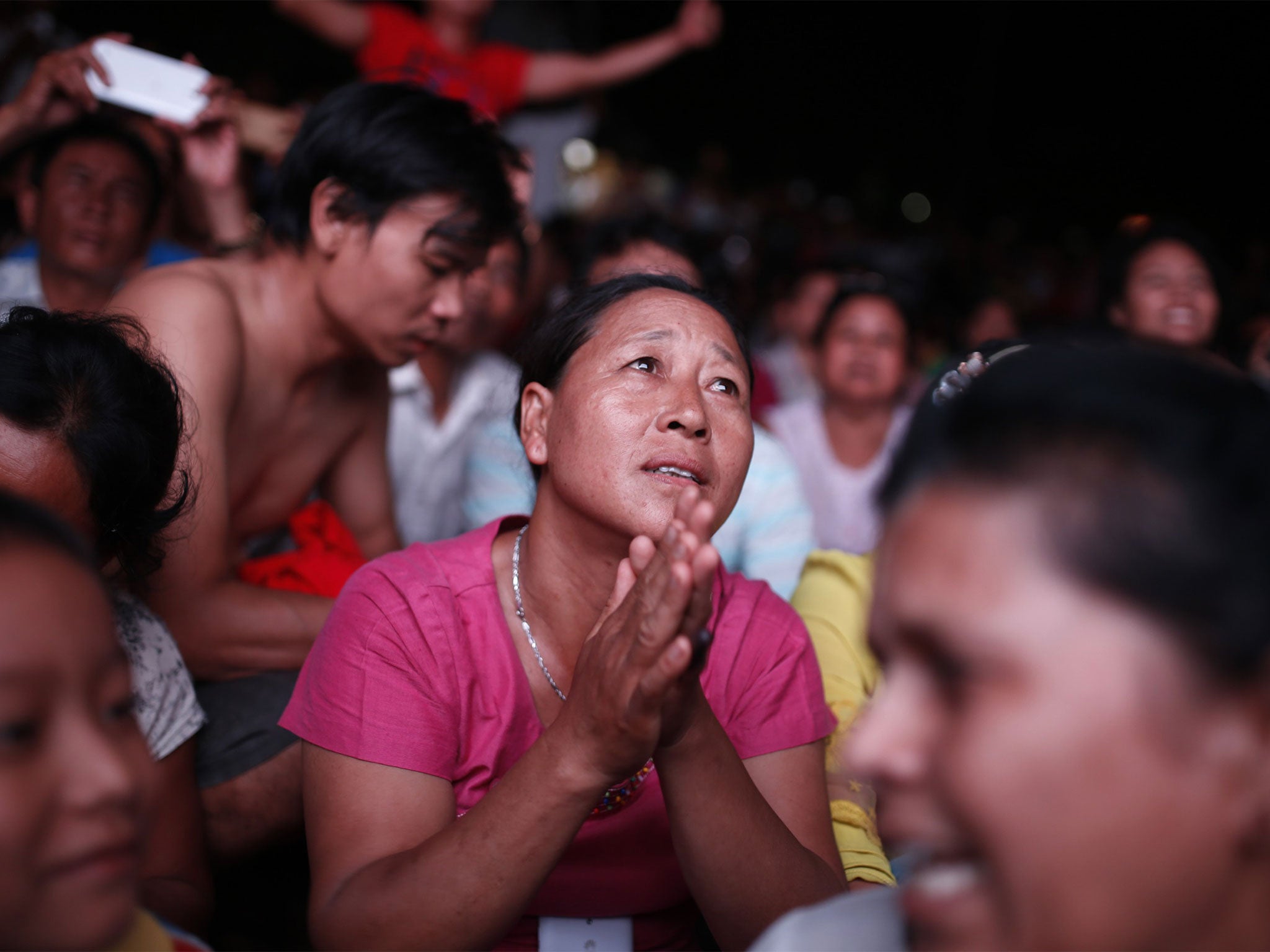 NLD supporters celebrate on Sunday night after voting closed