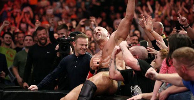 After winning his match, Cesaro celebrates with Rooney in the crowd