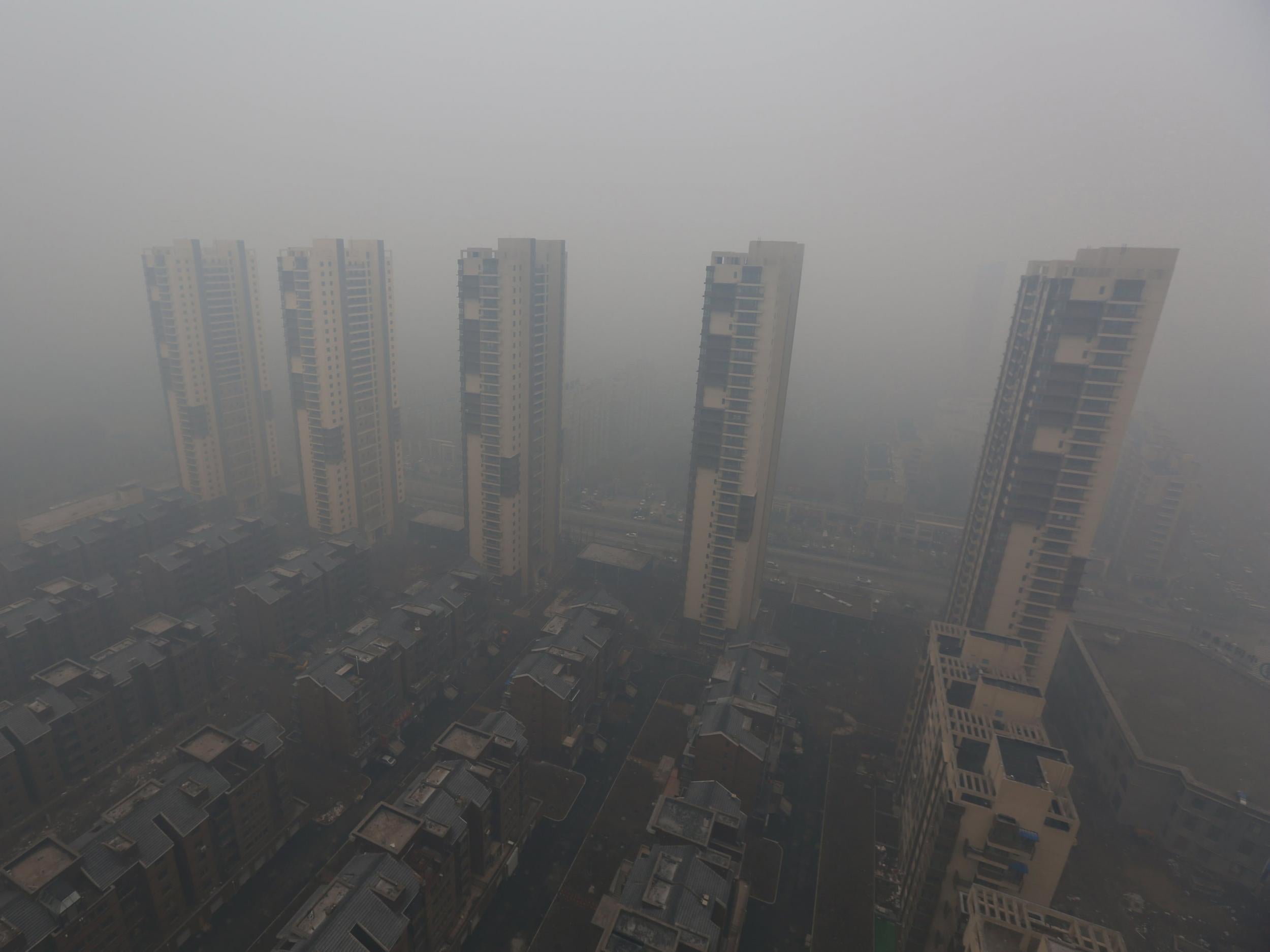 Residential buildings are seen shrouded in haze in Shenyang, Liaoning province