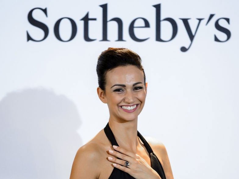 A model wears the 'Blue Moon' diamond during a 'Magnificent Jewels and Noble Jewels' sale from Sotheby's auction house on 11 November