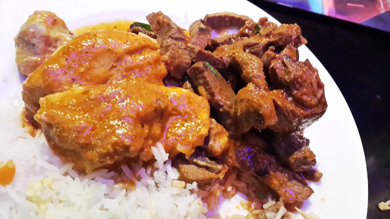 A plate of white rice, grilled chicken and sauteed beef