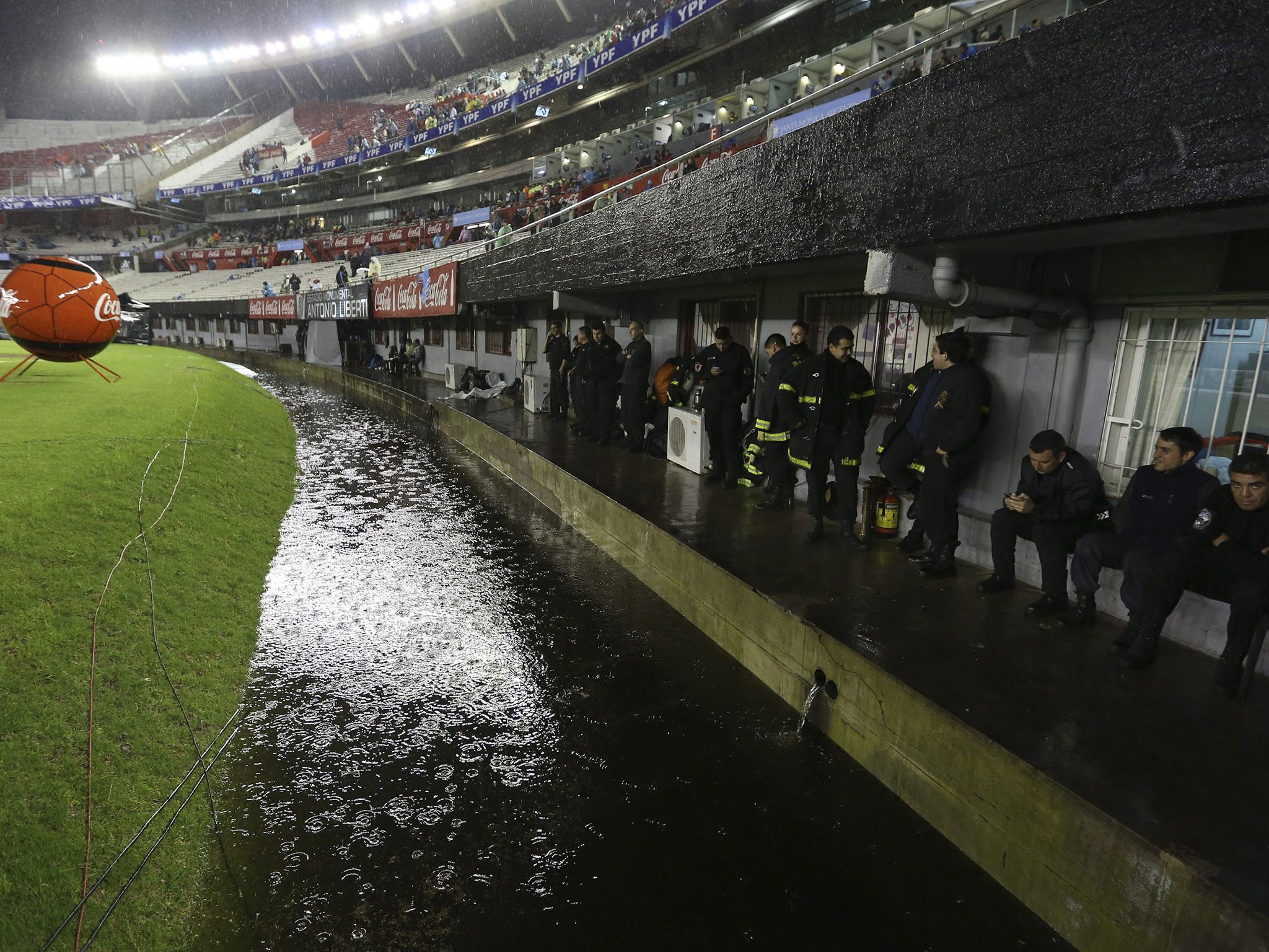 The dugout in the Monumental Stadium is flooded by torrential rain