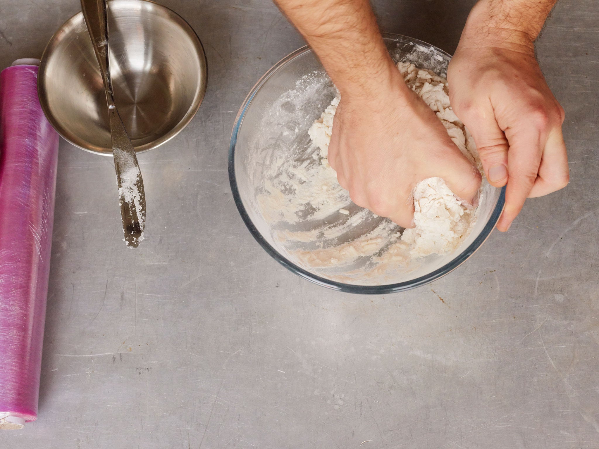 Gradually stir the water into the flour mix, eventually using one hand to pat together into a ball